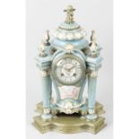 A late 19th/ early 20th century porcelain and gilt bronze cased mantel clock.