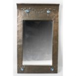 An Arts and Crafts copper framed wall mirror.