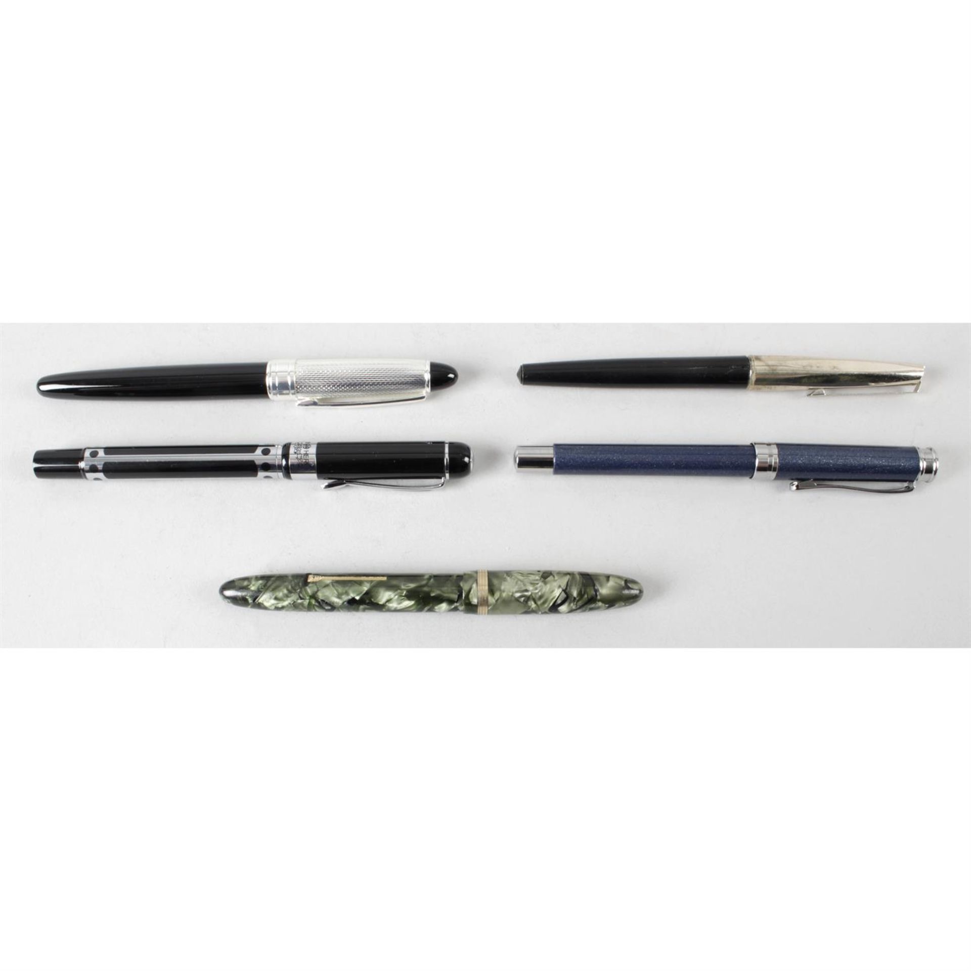 A selection of five assorted fountain pens.