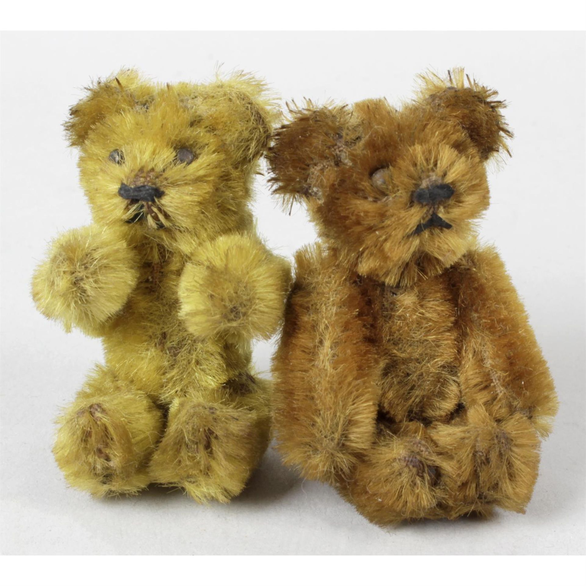 A mid-20th century Schuco miniature teddy bear, and similar gold plush example. (2)