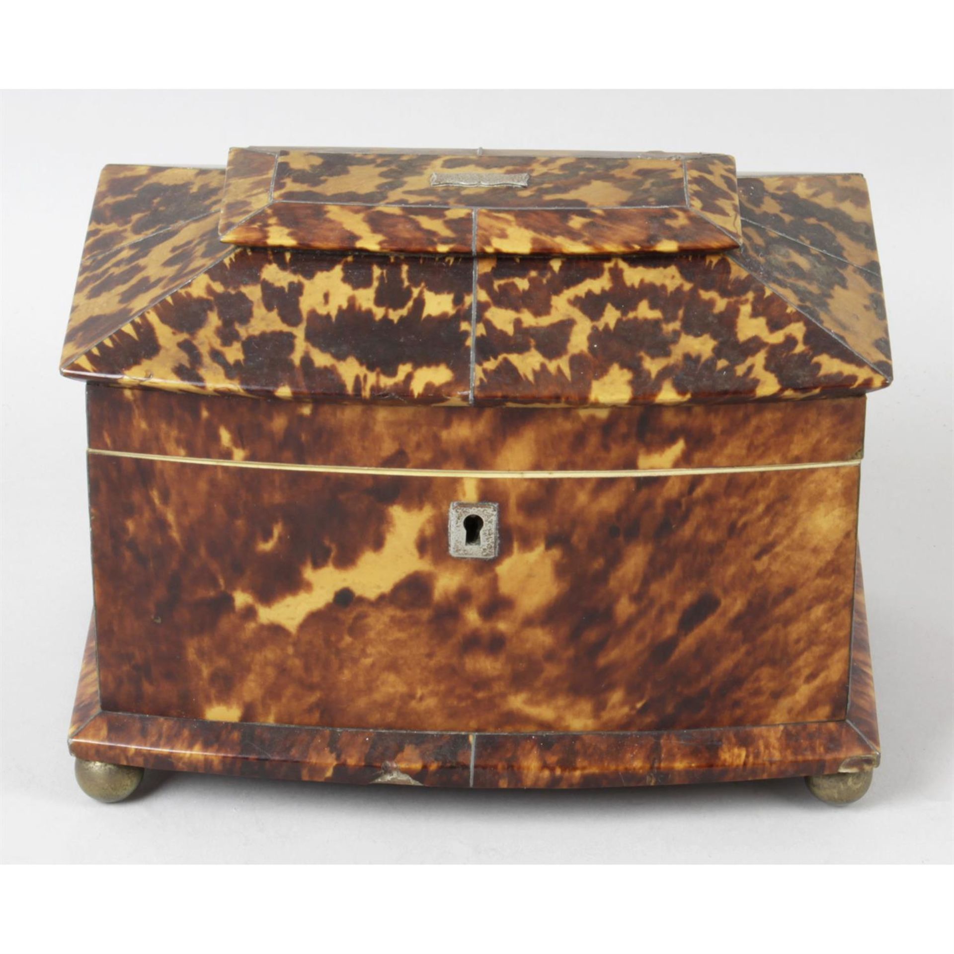 A 19th century tortoiseshell veneered tea caddy.