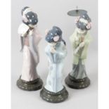 A group of four Lladro figurines.