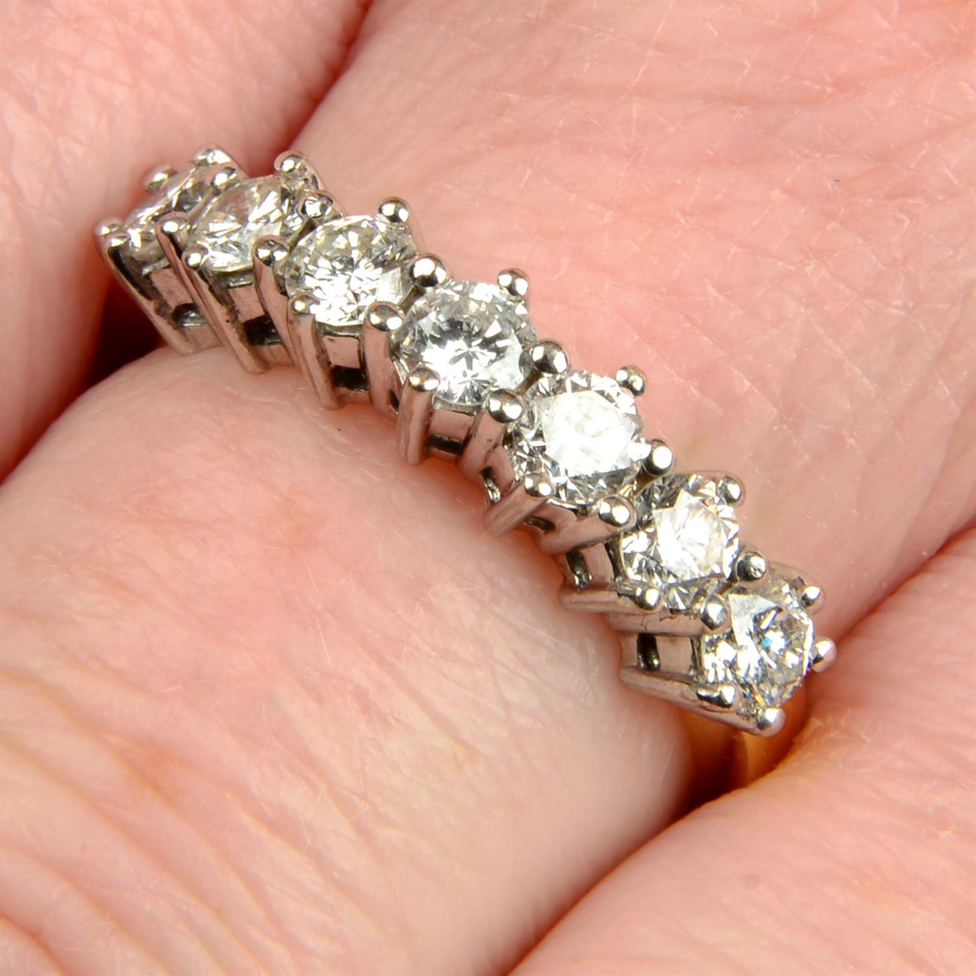 An 18ct gold brilliant-cut diamond half eternity ring.