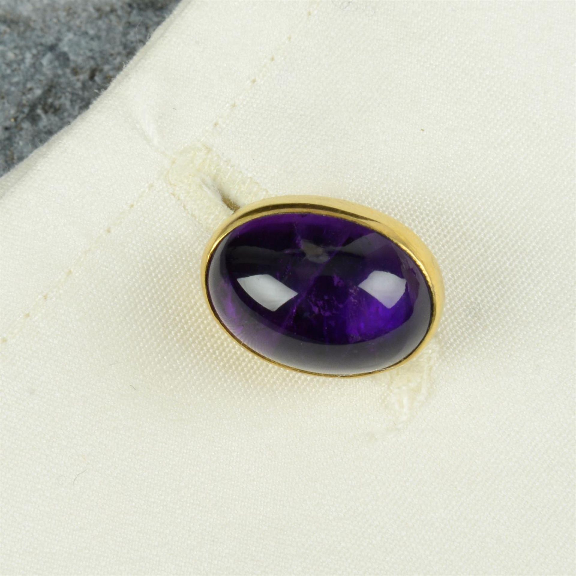 A pair of mid 20th century 9ct gold amethyst cabochon cufflinks.