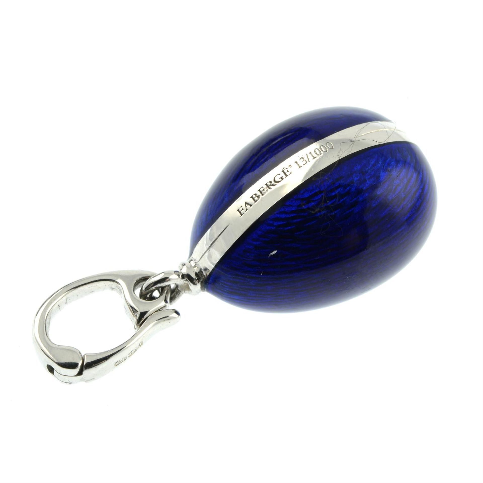 A limited edition 18ct gold blue enamel egg pendant, with diamond swan highlight, by Fabergé. - Image 4 of 5