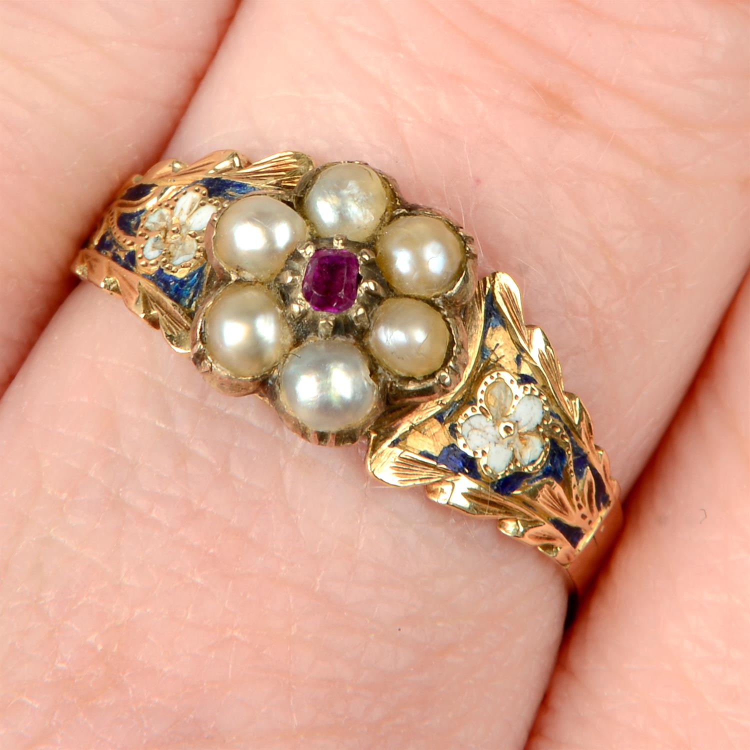 A 19th century gold ruby and split pearl cluster ring, with enamel pansy shoulders.