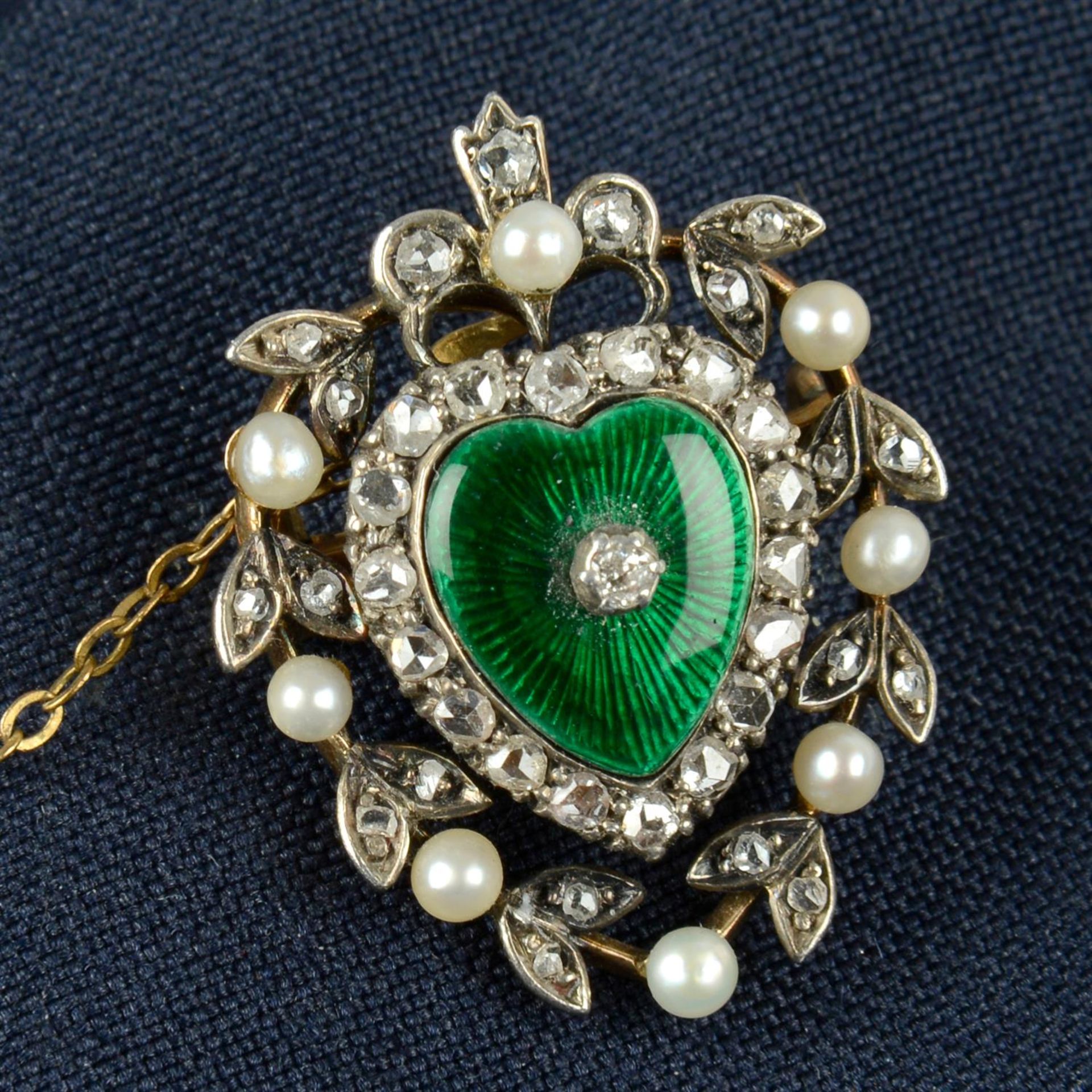 A late Victorian silver and gold, rose-cut diamond, seed pearl and green enamel heart