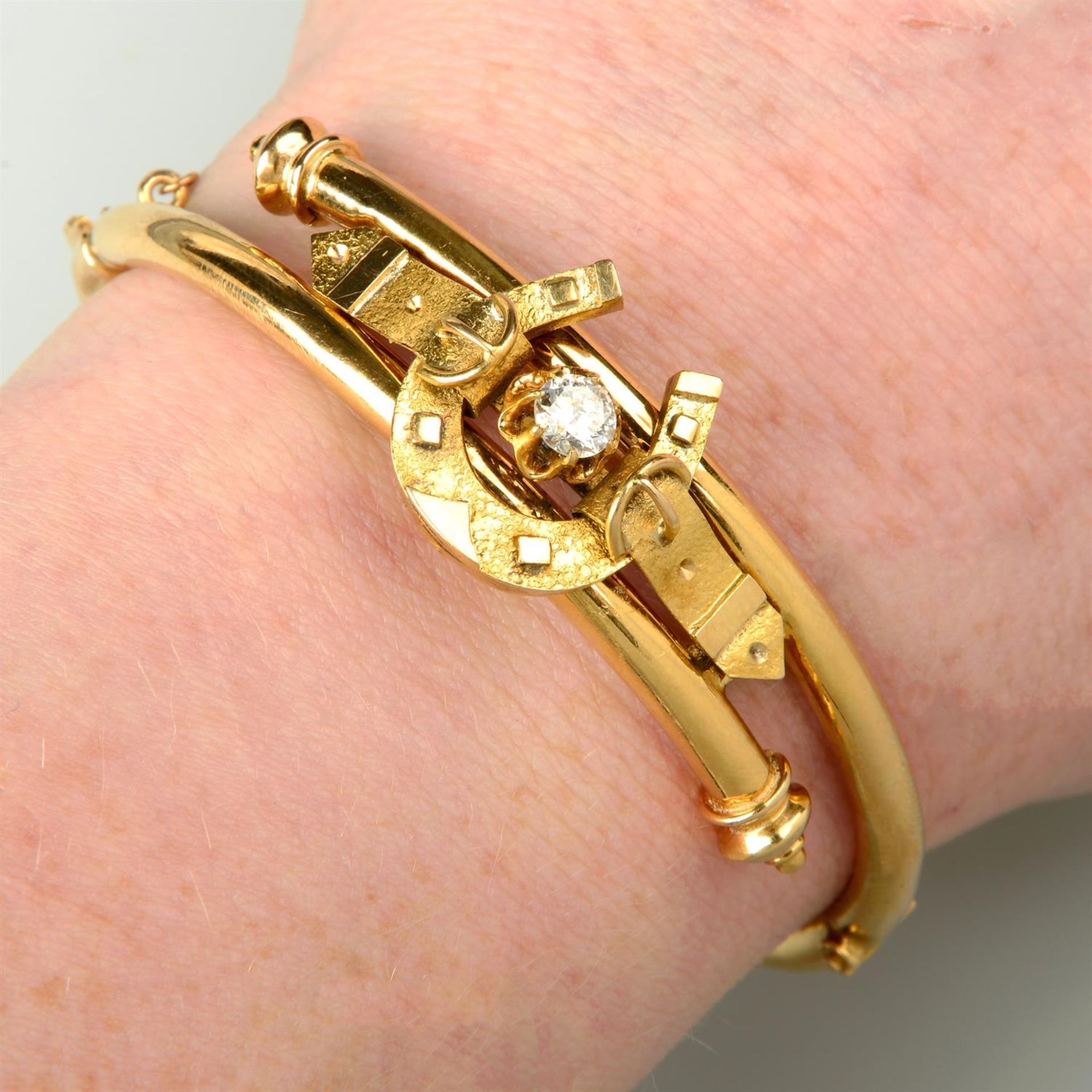 A late Victorian gold old-cut diamond horseshoe and buckle hinged bangle, together with matching