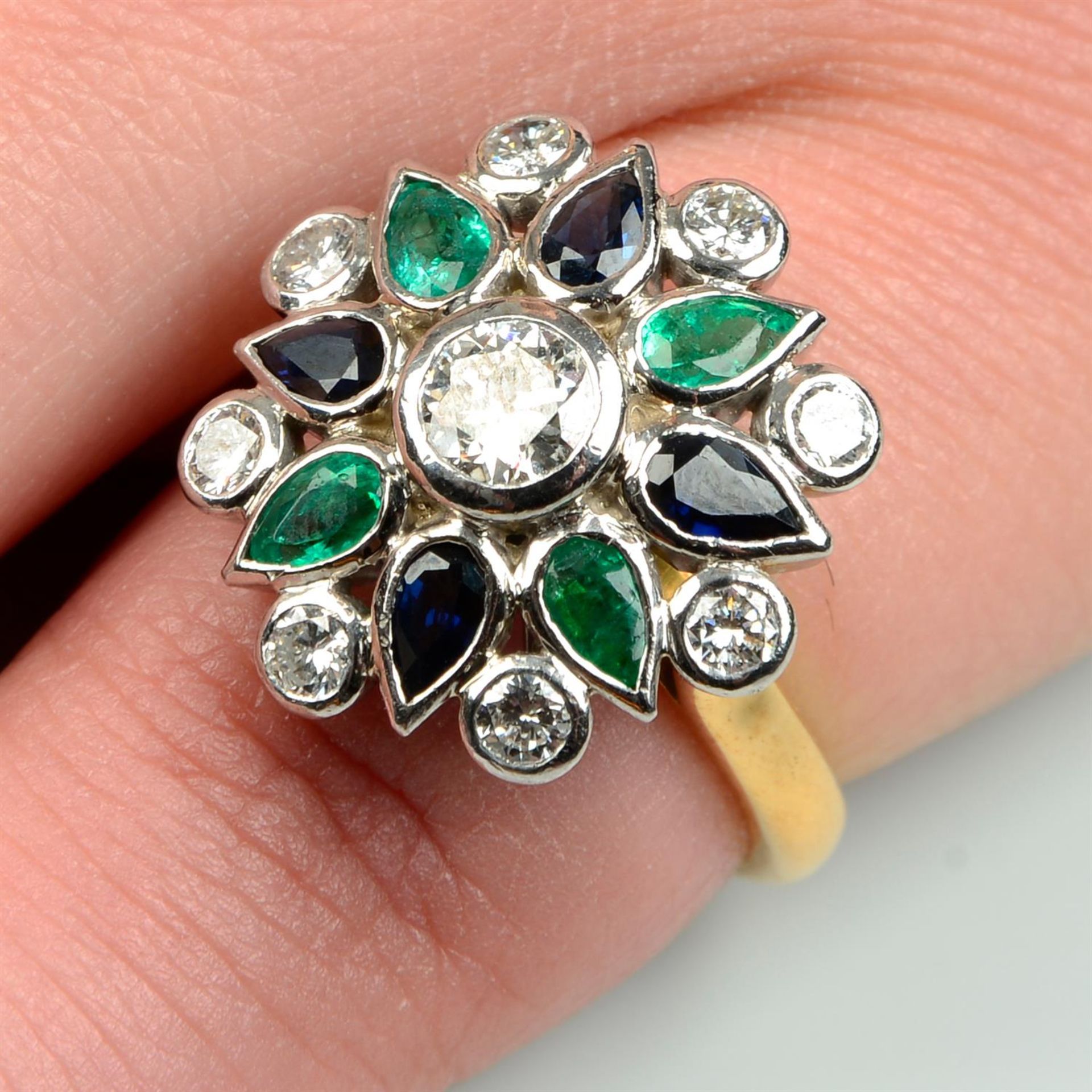 An 18ct gold brilliant-cut diamond, sapphire and emerald floral dress ring, by Theo Fennell.