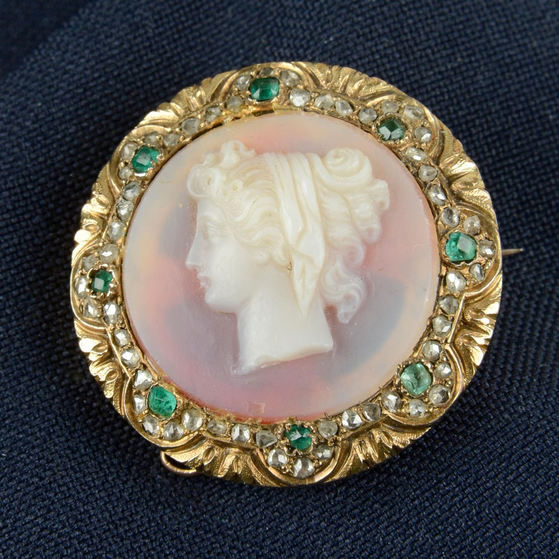A mid Victorian gold sardonyx cameo brooch, depicting Hera in profile, with emerald and rose-cut