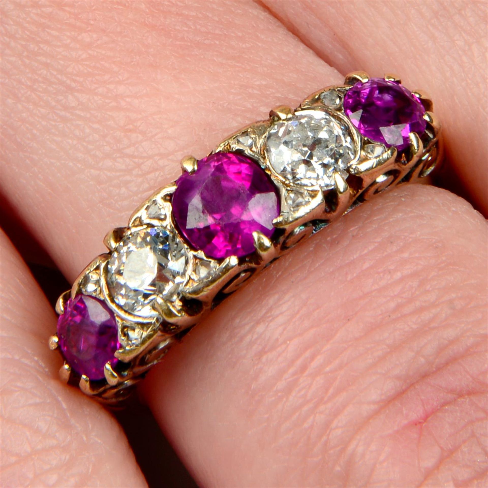 An early 20th century 18ct gold alternating ruby and old-cut diamond five-stone ring.