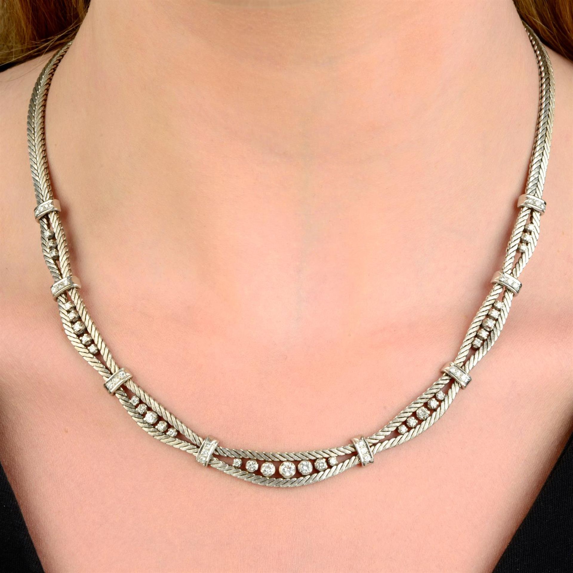 A mid 20th century 18ct gold textured herringbone-link necklace, with brilliant-cut diamond spacers.