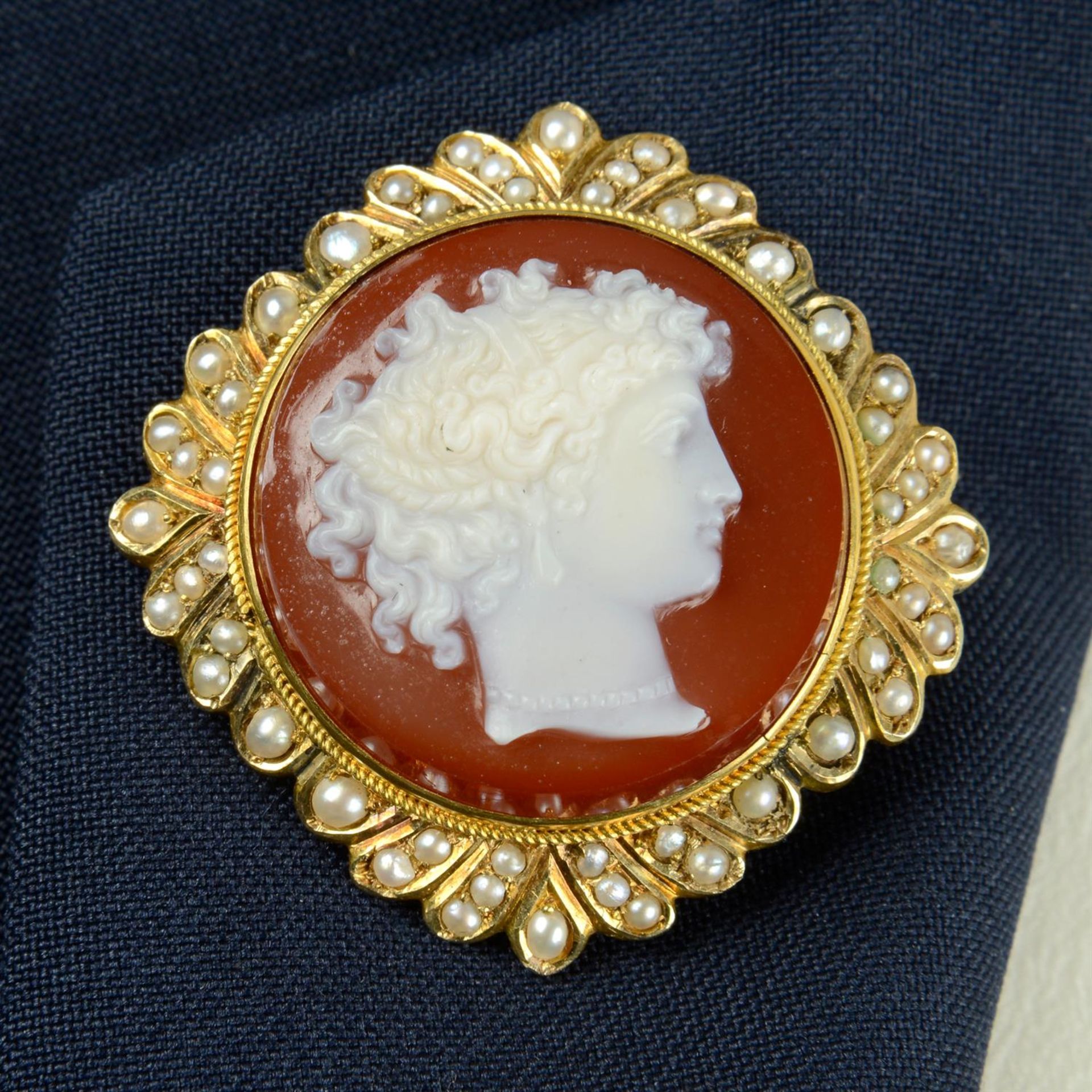 A late 19th century sardonyx cameo brooch, with split pearl surround.
