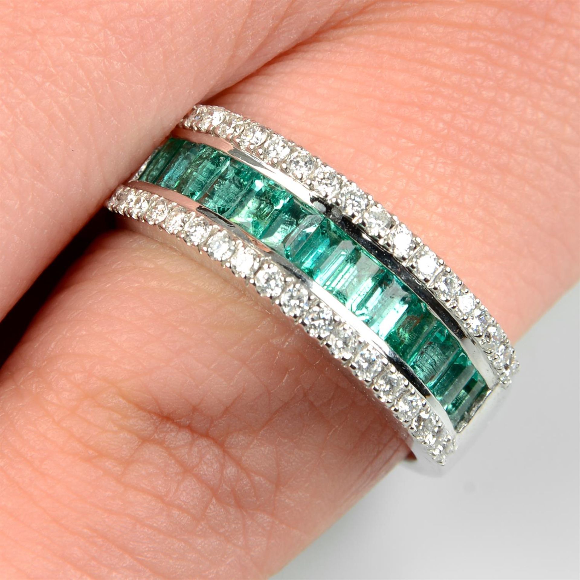 An 18ct gold emerald and brilliant-cut diamond three-row dress ring.