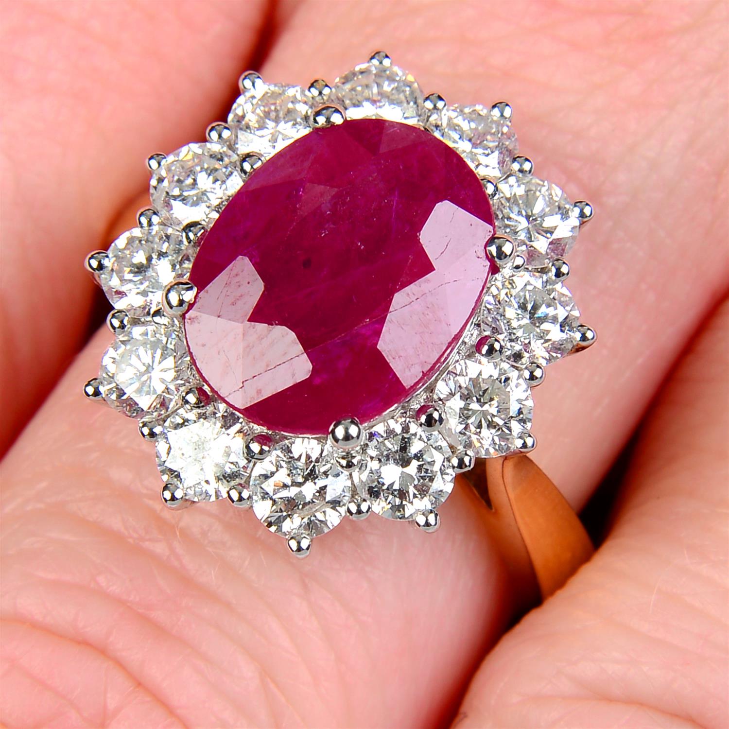 An 18ct gold ruby and brilliant-cut diamond cluster ring.