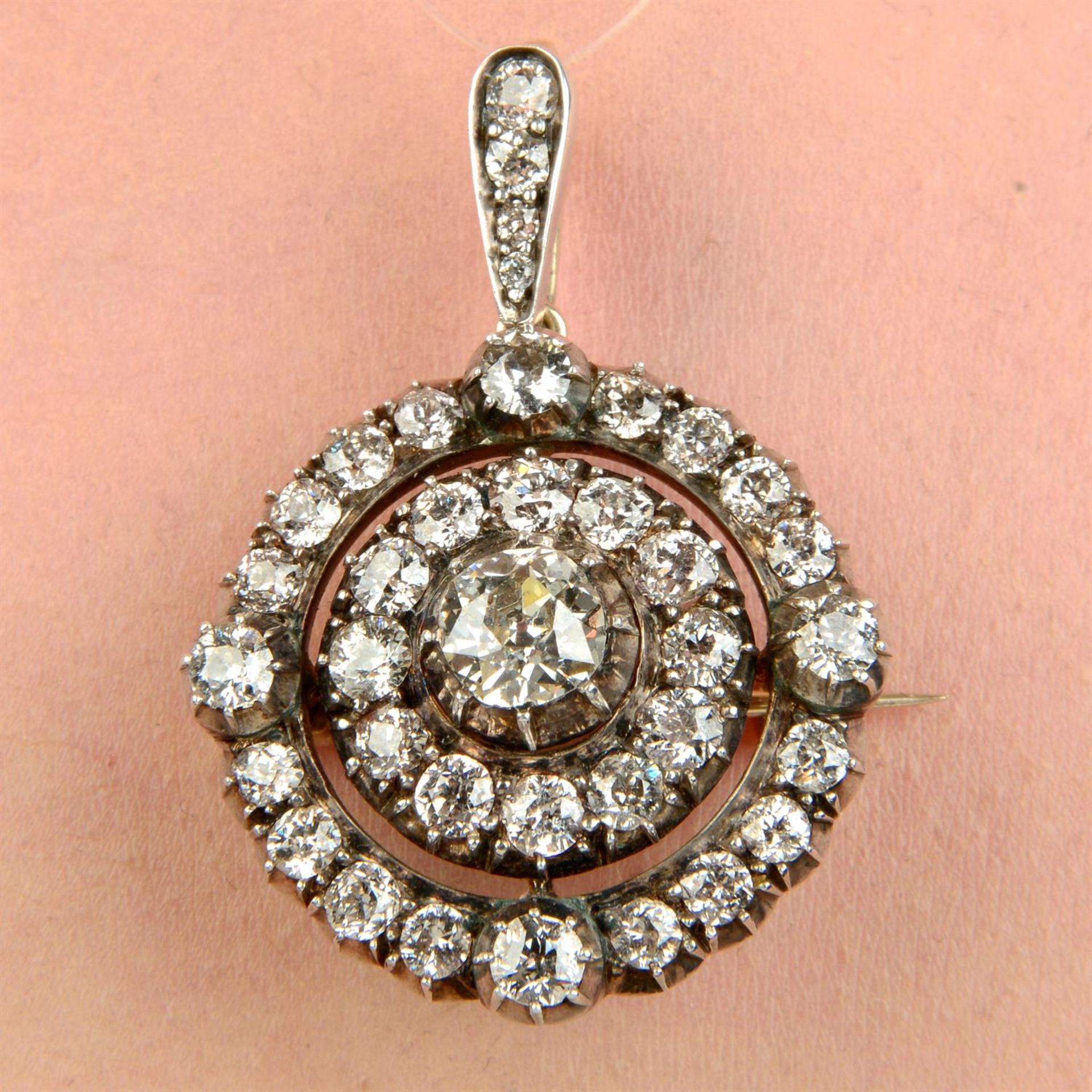 A late Victorian silver and gold old-cut diamond target pendant/brooch.