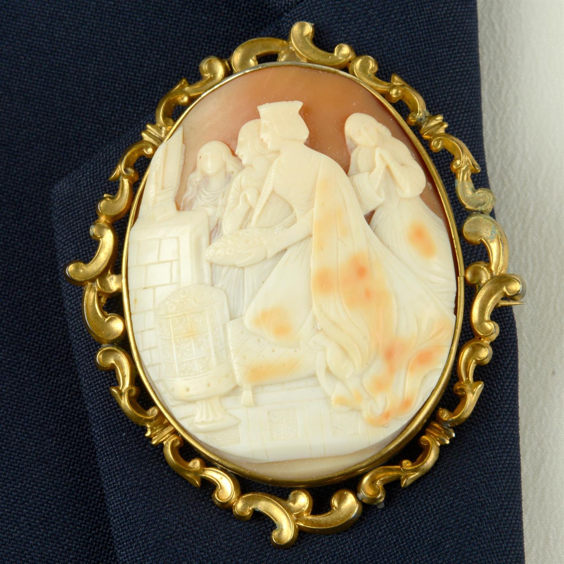 A late Victorian gold mounted shell cameo brooch, carved to depict a Queen, possibly giving