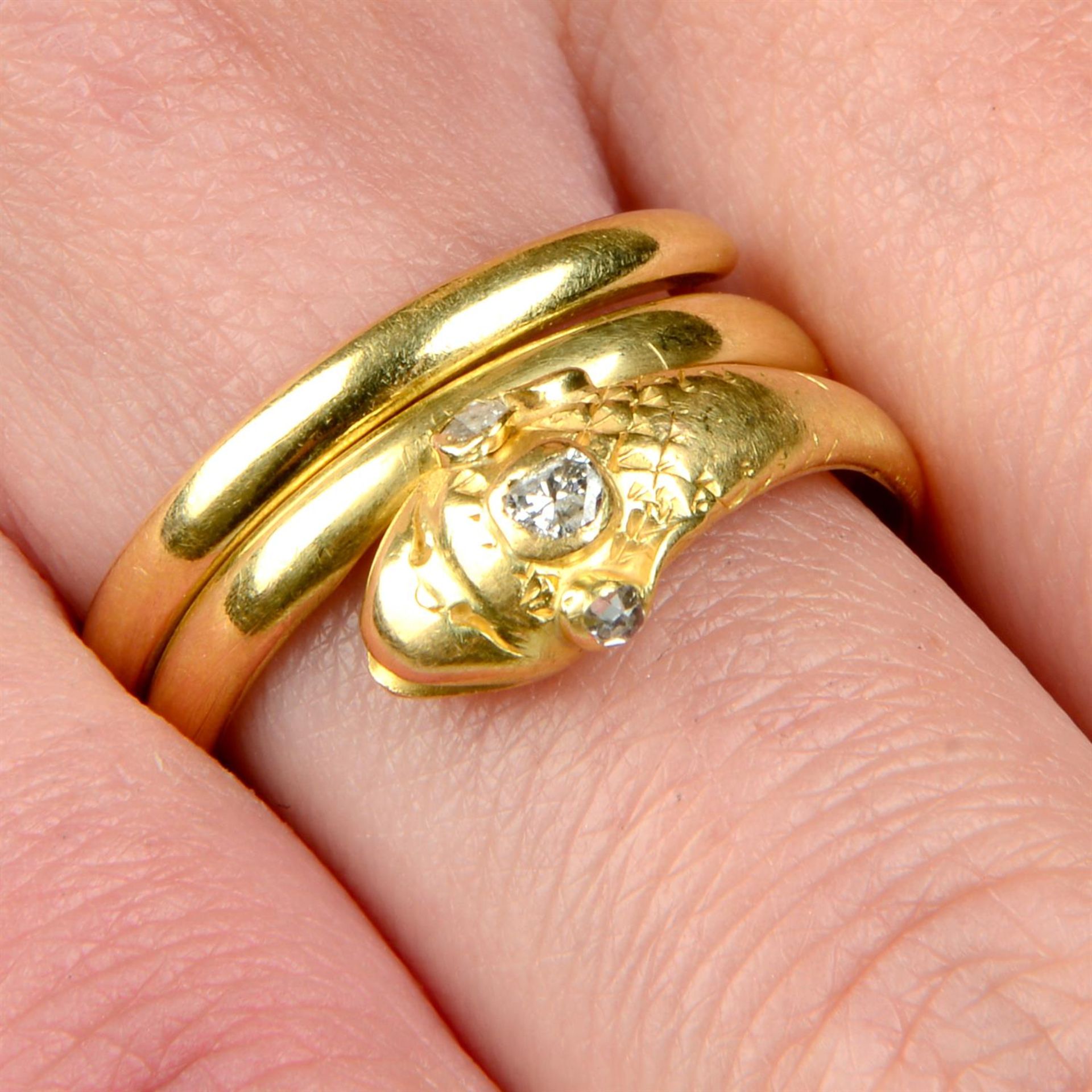 A mid Victorian 18ct gold snake ring, with diamond crest and eyes.