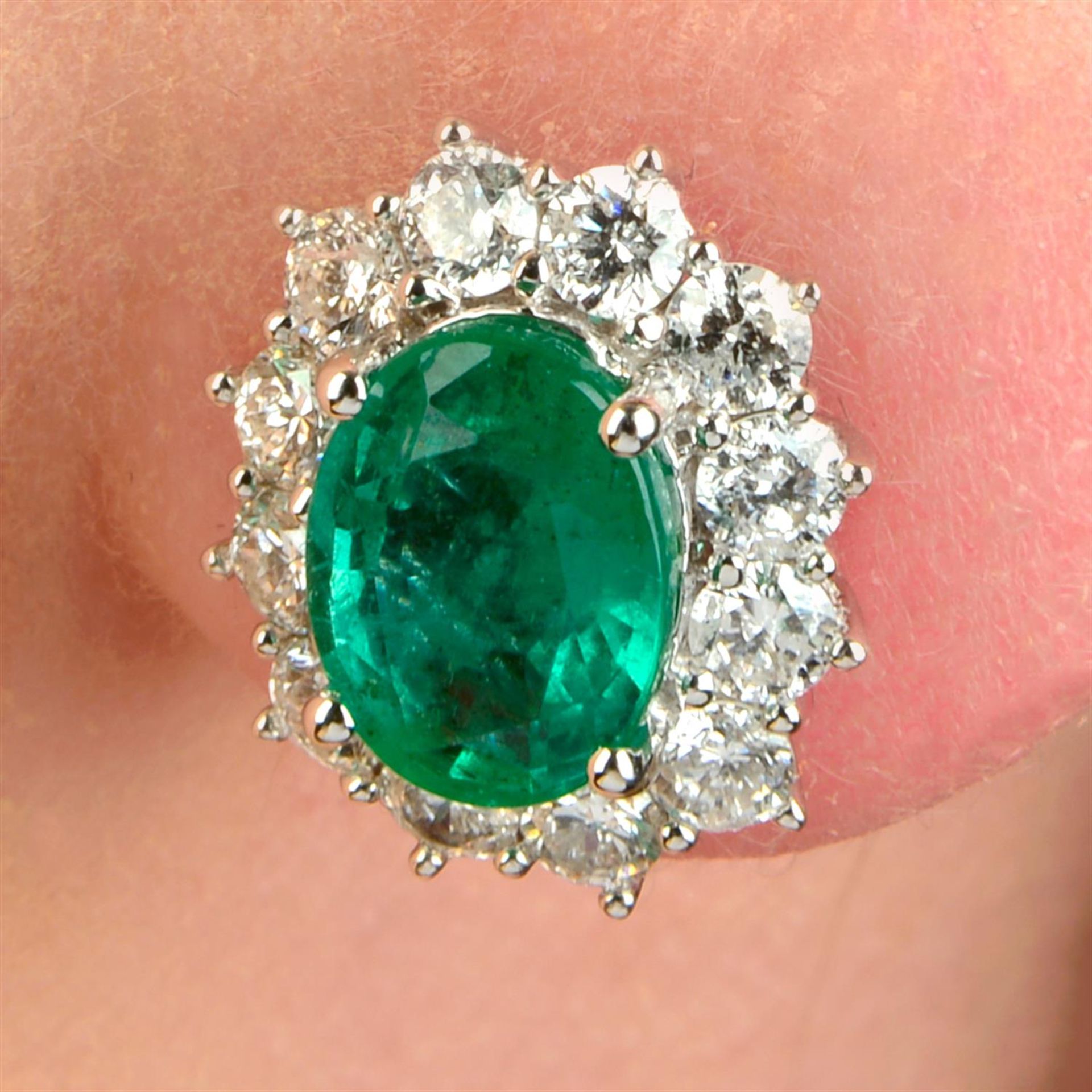 A pair of 18ct gold emerald and brilliant-cut diamond cluster earrings.