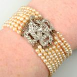 An early 20th century multi-strand pearl bracelet, with platinum and gold old and rose-cut diamond