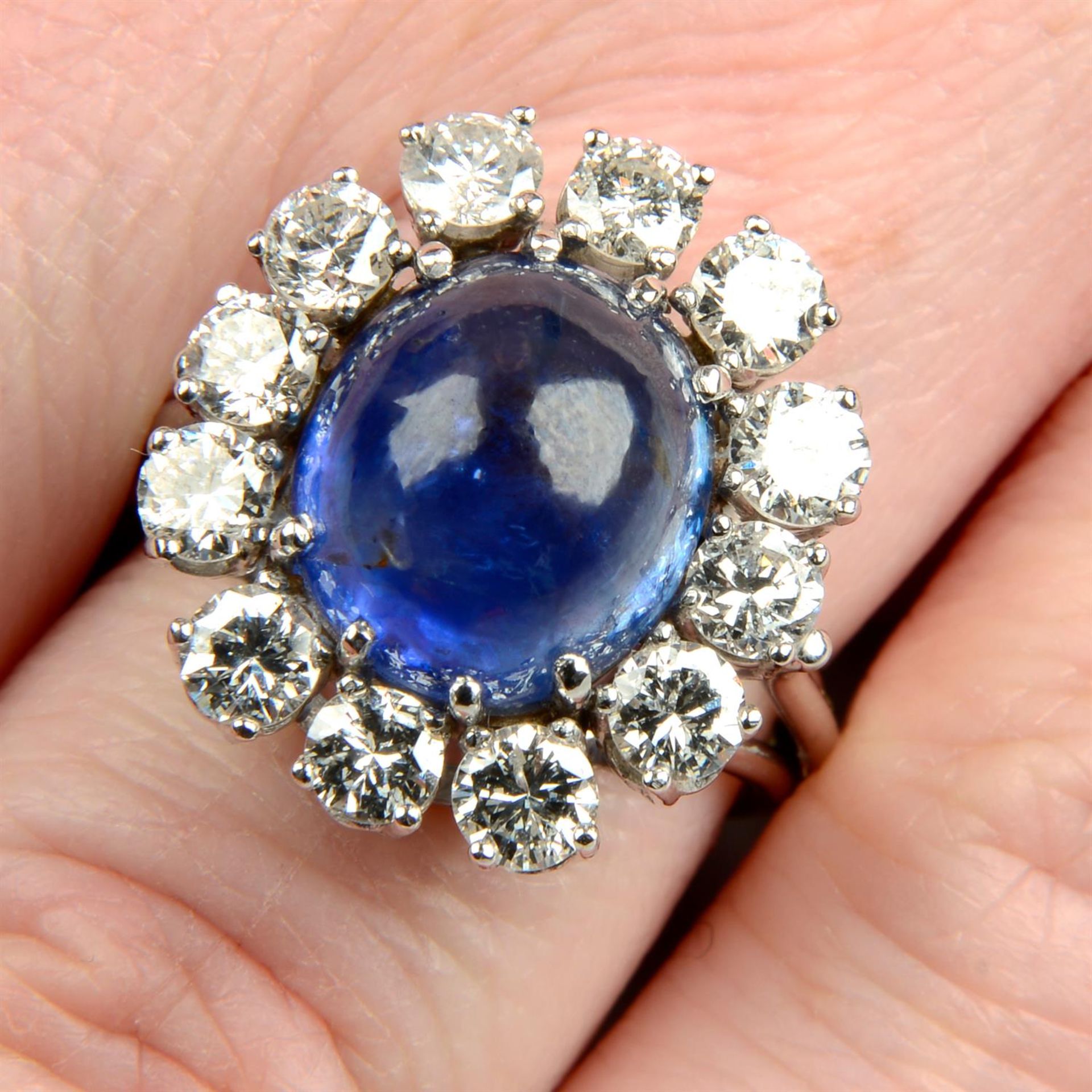 A mid 20th century gold Sri Lankan sapphire and brilliant-cut diamond cluster ring.