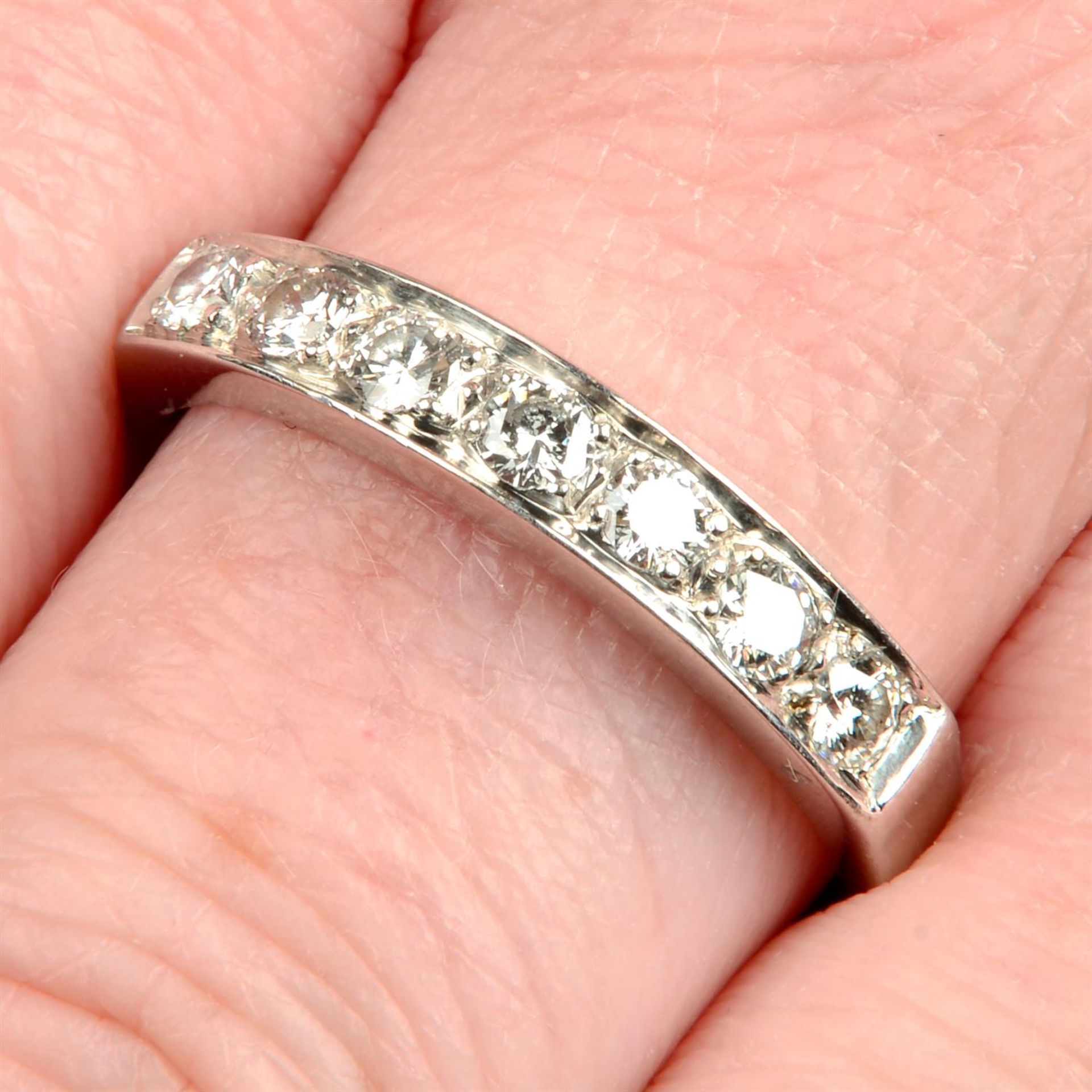 An 18ct gold brilliant-cut diamond half eternity ring.