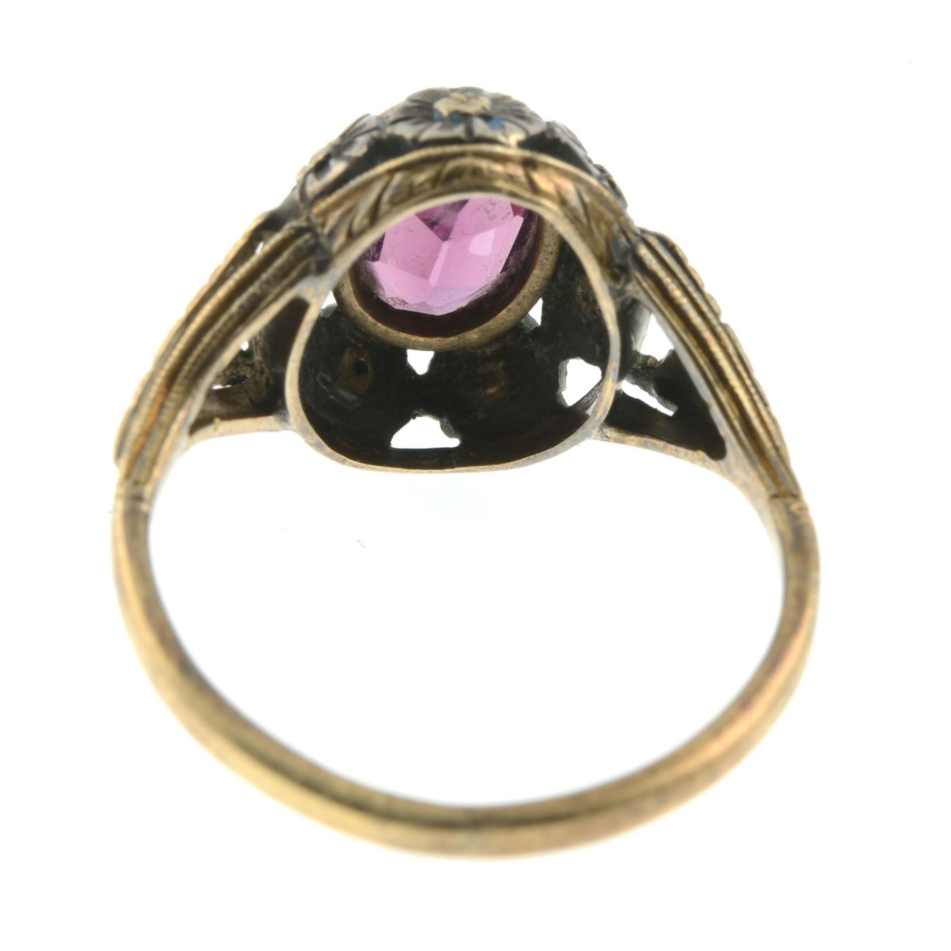 An early 20th century silver and 15ct gold garnet dress ring, with pierced floral surround. - Image 4 of 5
