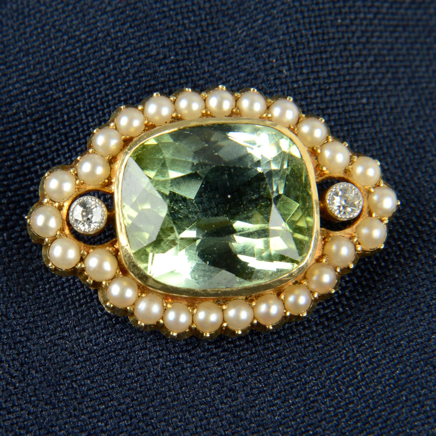 A late 19th century gold green tourmaline brooch, with split pearl and old-cut diamond surround.