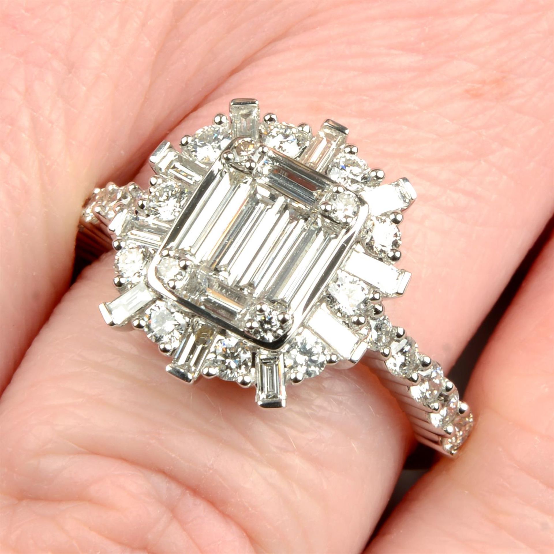 A baguette and brilliant-cut diamond dress ring.