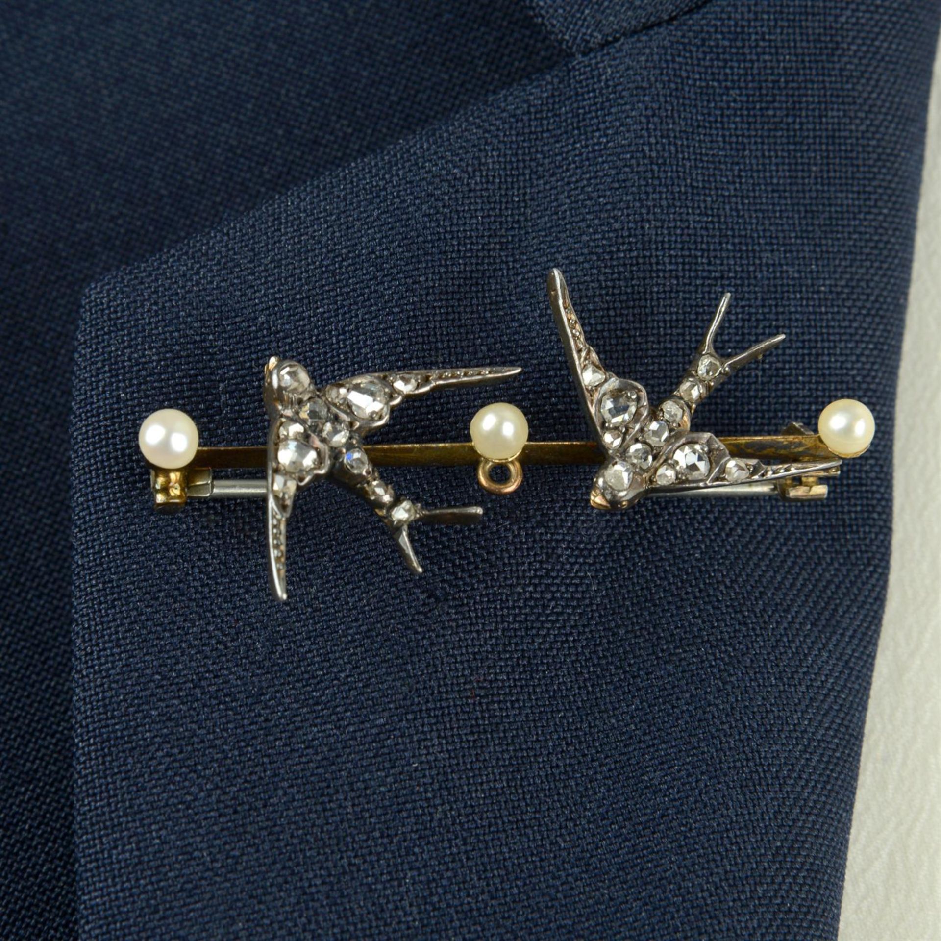 A late Victorian silver and gold rose-cut diamond swallow and seed pearl bar brooch.