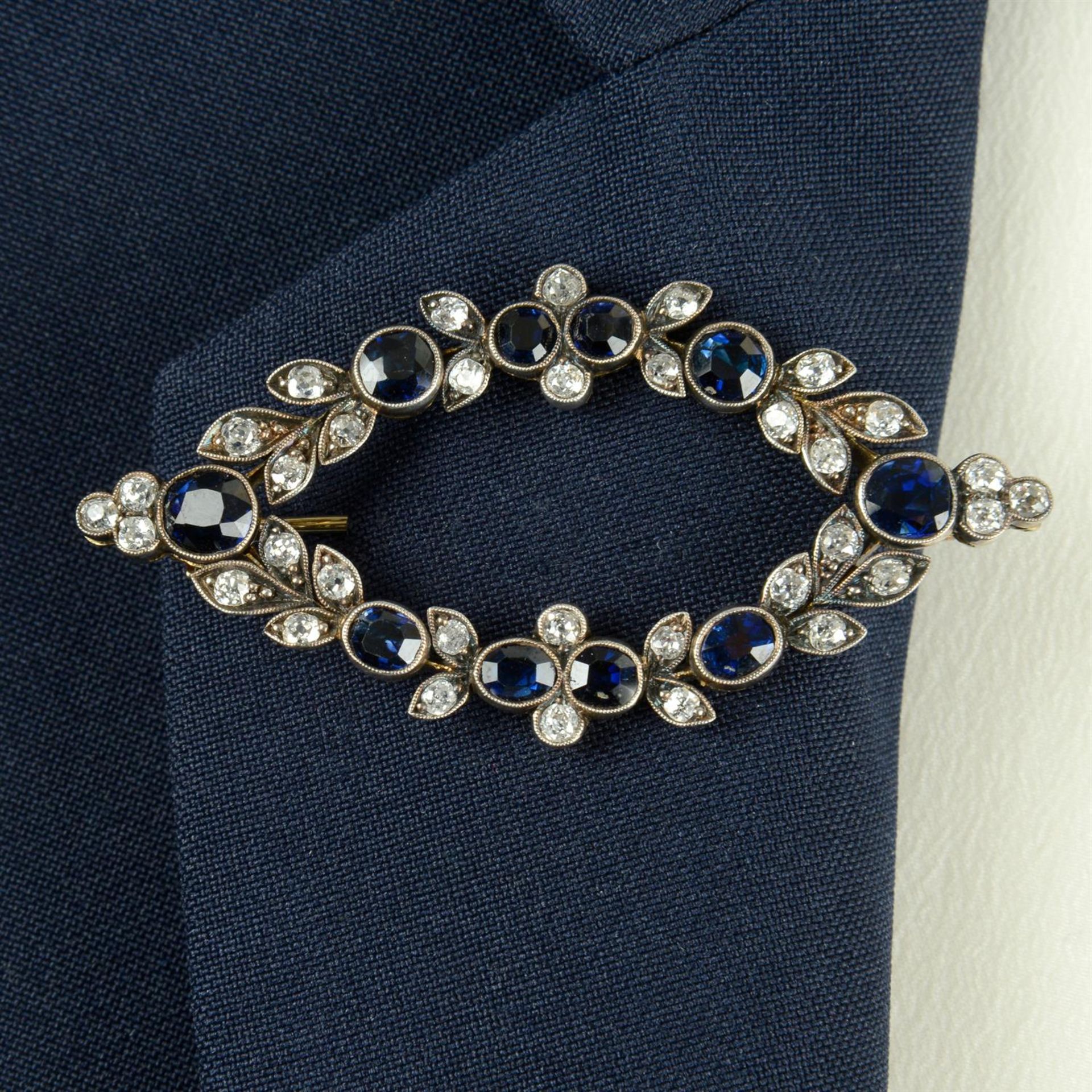 An early 20th century silver and gold sapphire and old-cut diamond marquise-shape foliate brooch.
