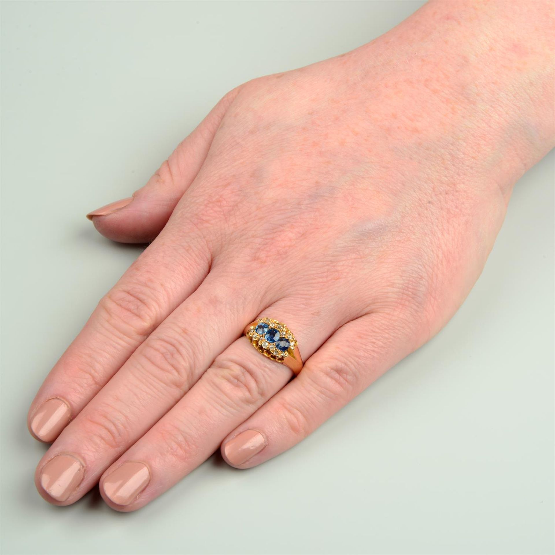 A late Victorian 18ct gold sapphire three-stone ring, with rose and old-cut diamond surround. - Image 6 of 6