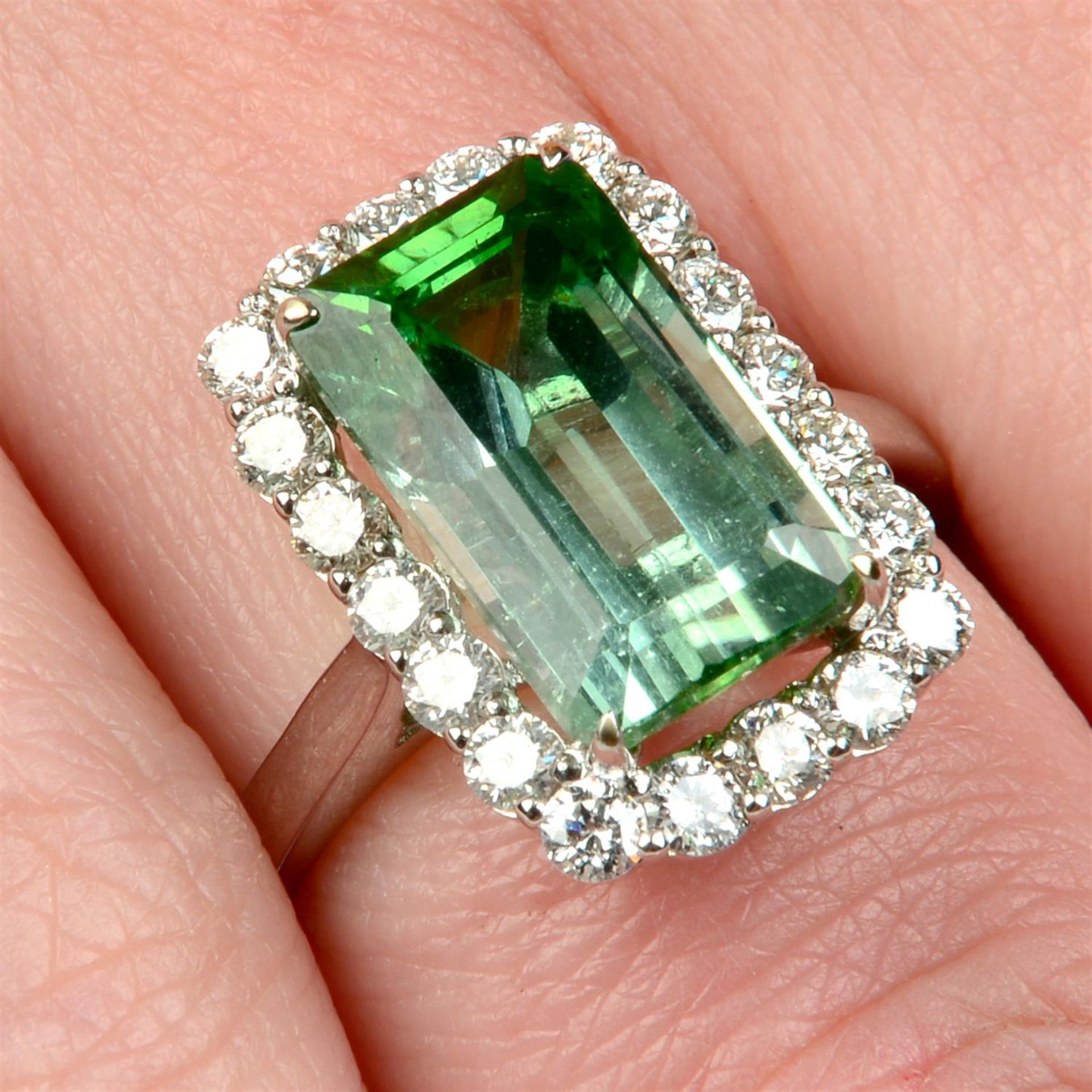 A green tourmaline and brilliant-cut diamond cluster ring.