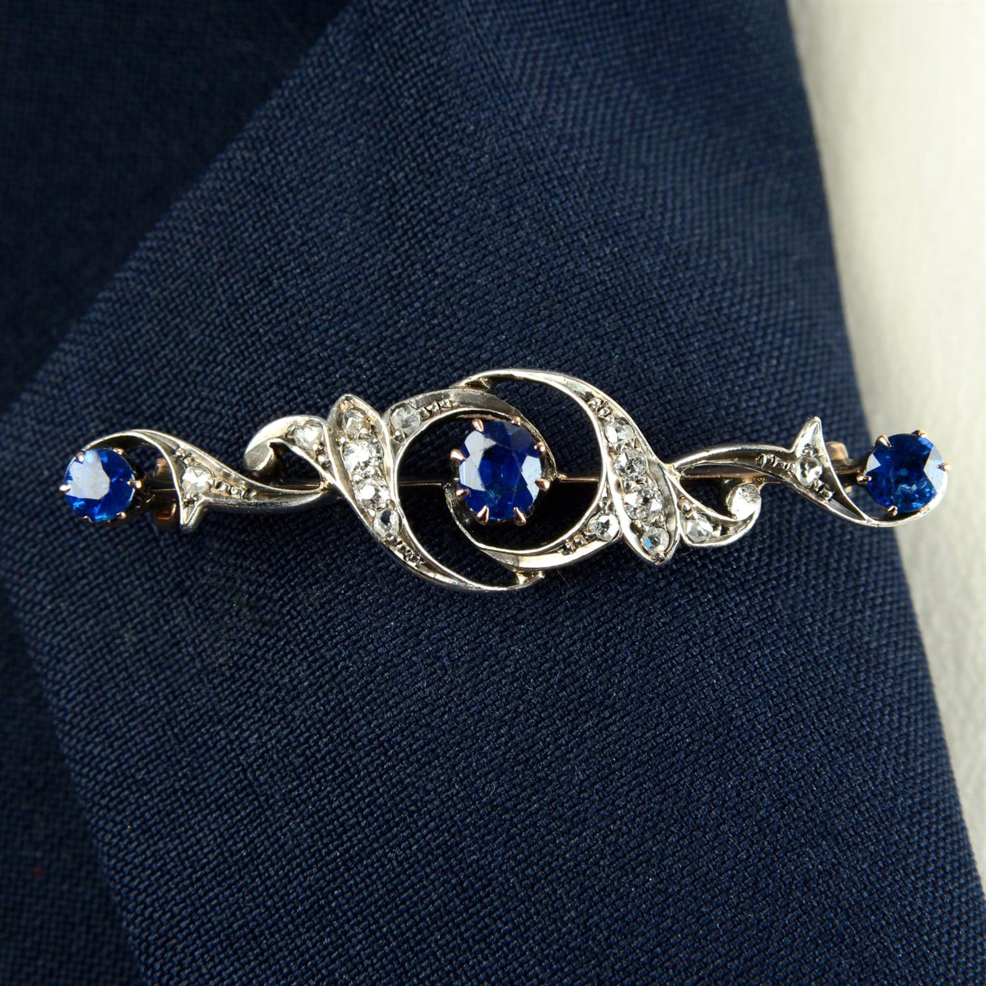 A late Victorian silver and gold, sapphire and vari-cut diamond foliate brooch.