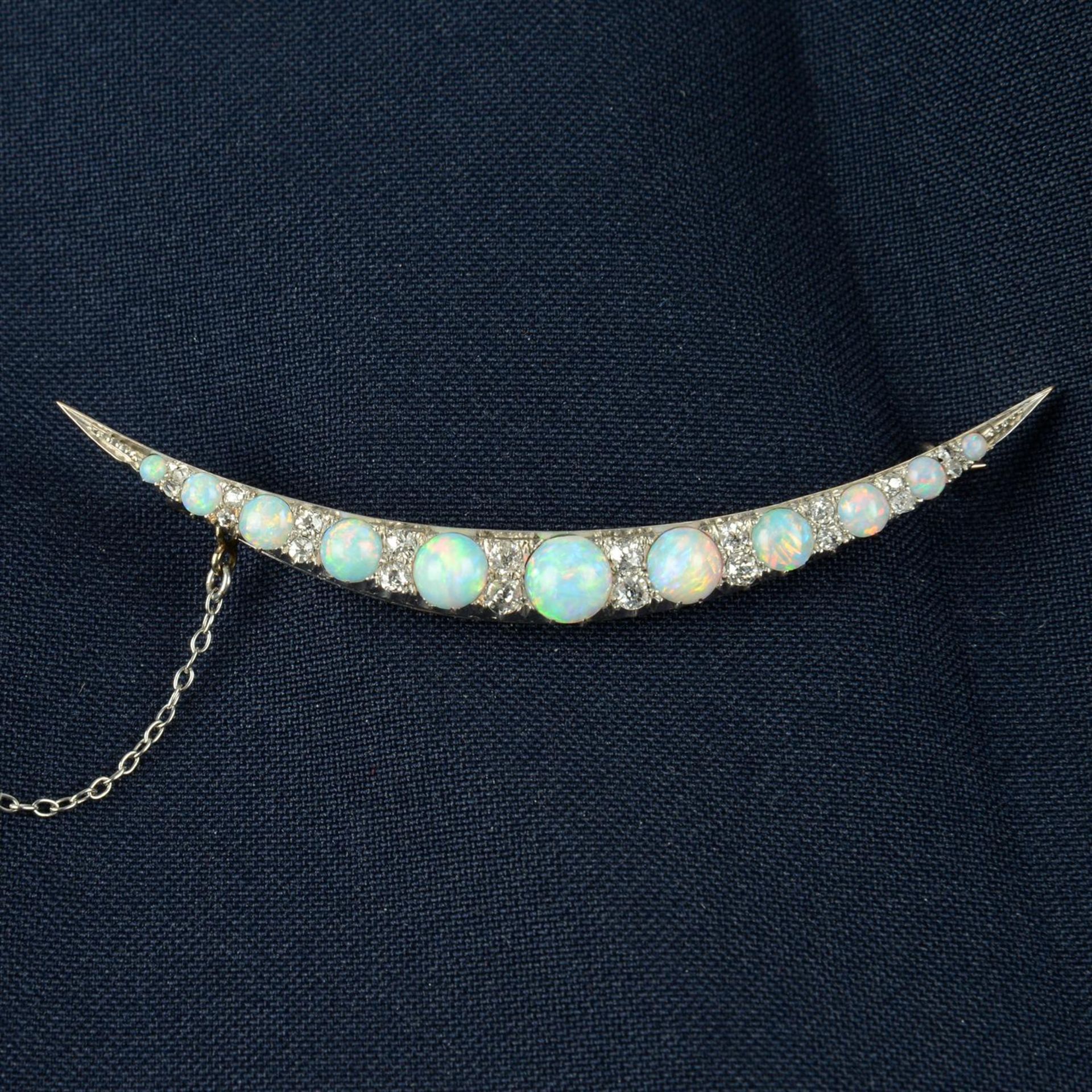 A late Victorian silver and gold graduated opal cabochon and old-cut diamond spacer crescent moon