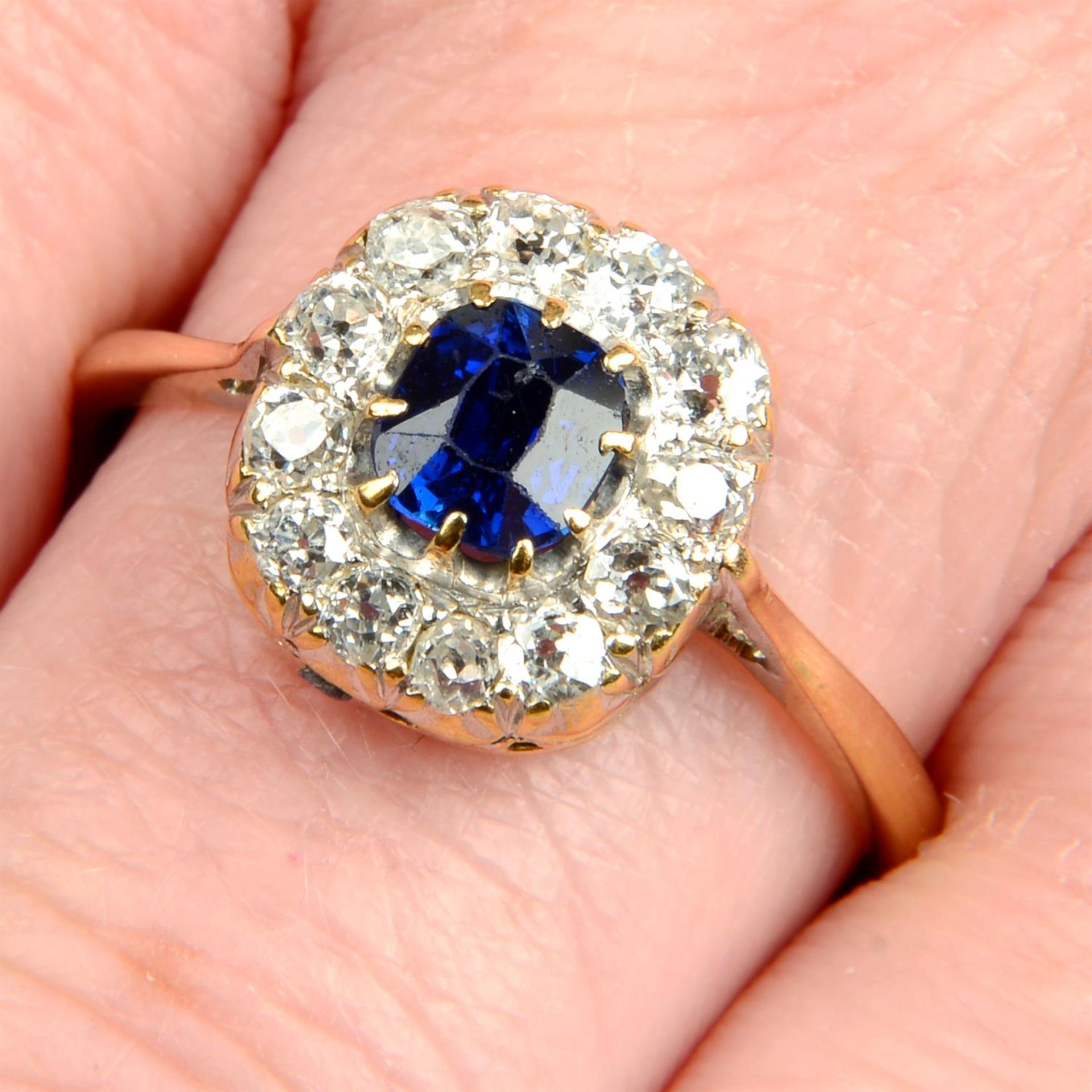 An early to mid 20th century 18ct gold sapphire and old-cut diamond cluster ring.