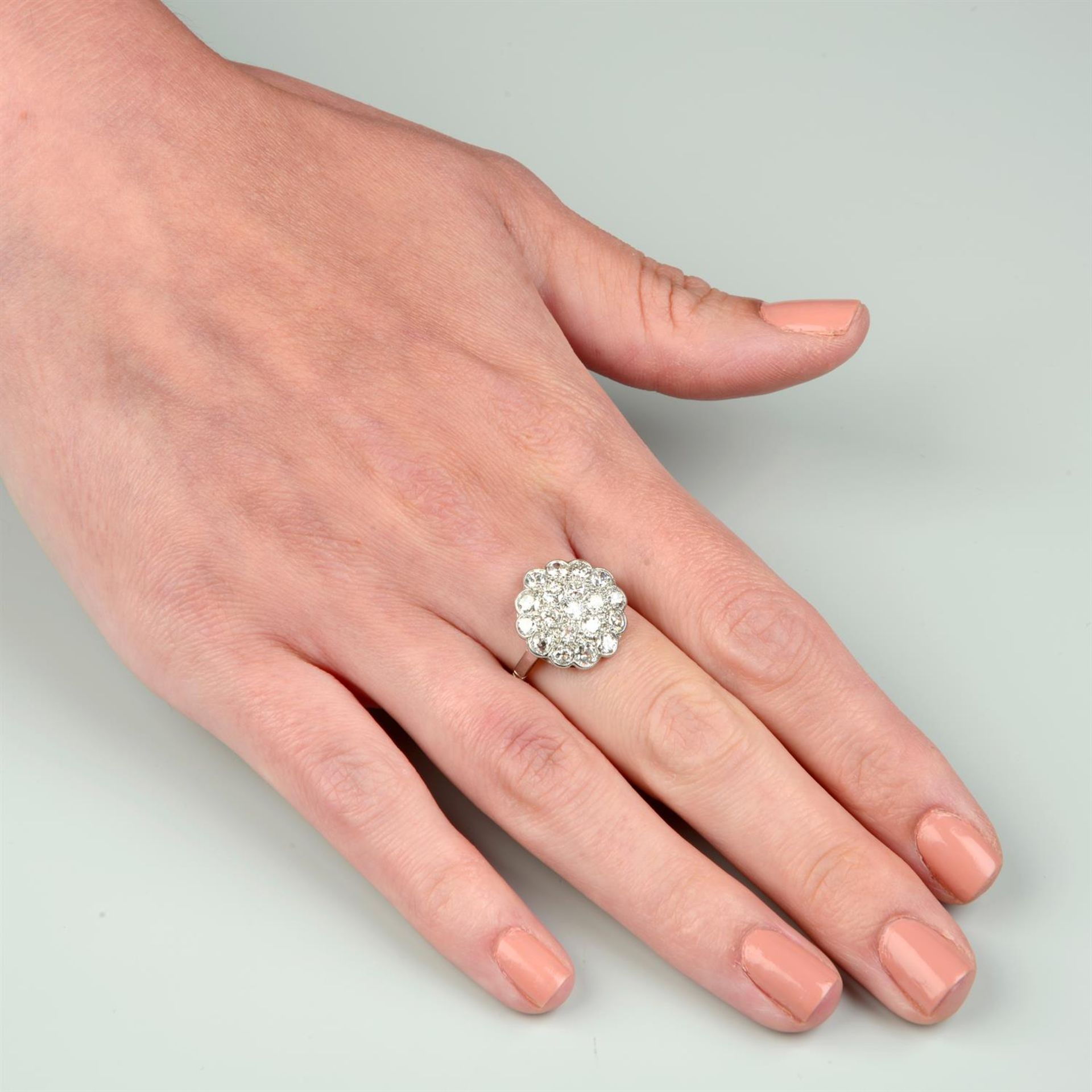 An early to mid 20th century platinum circular-cut diamond cluster ring. - Image 5 of 5