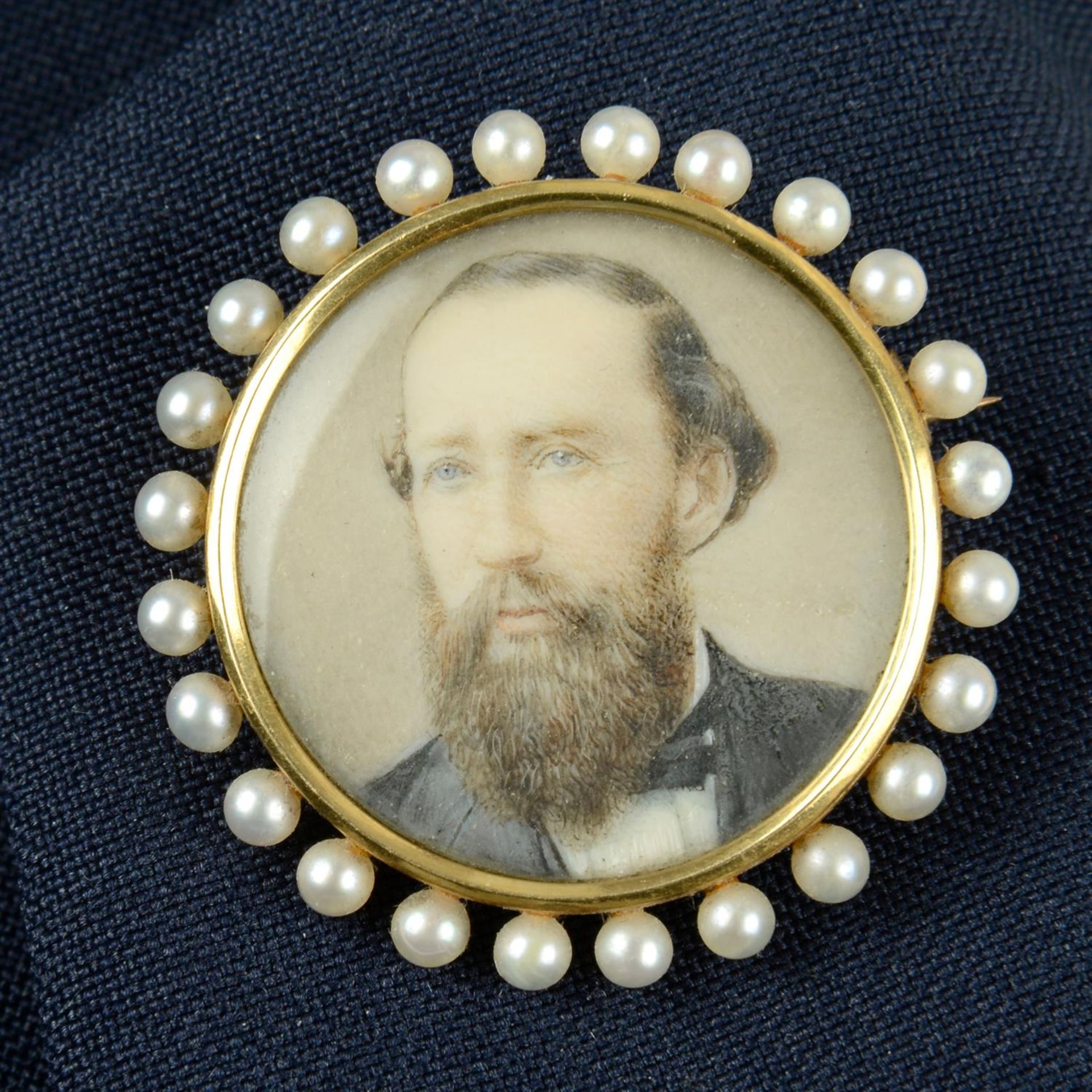 An early 20th century 18ct gold and seed pearl mounted portrait miniature brooch of a bearded