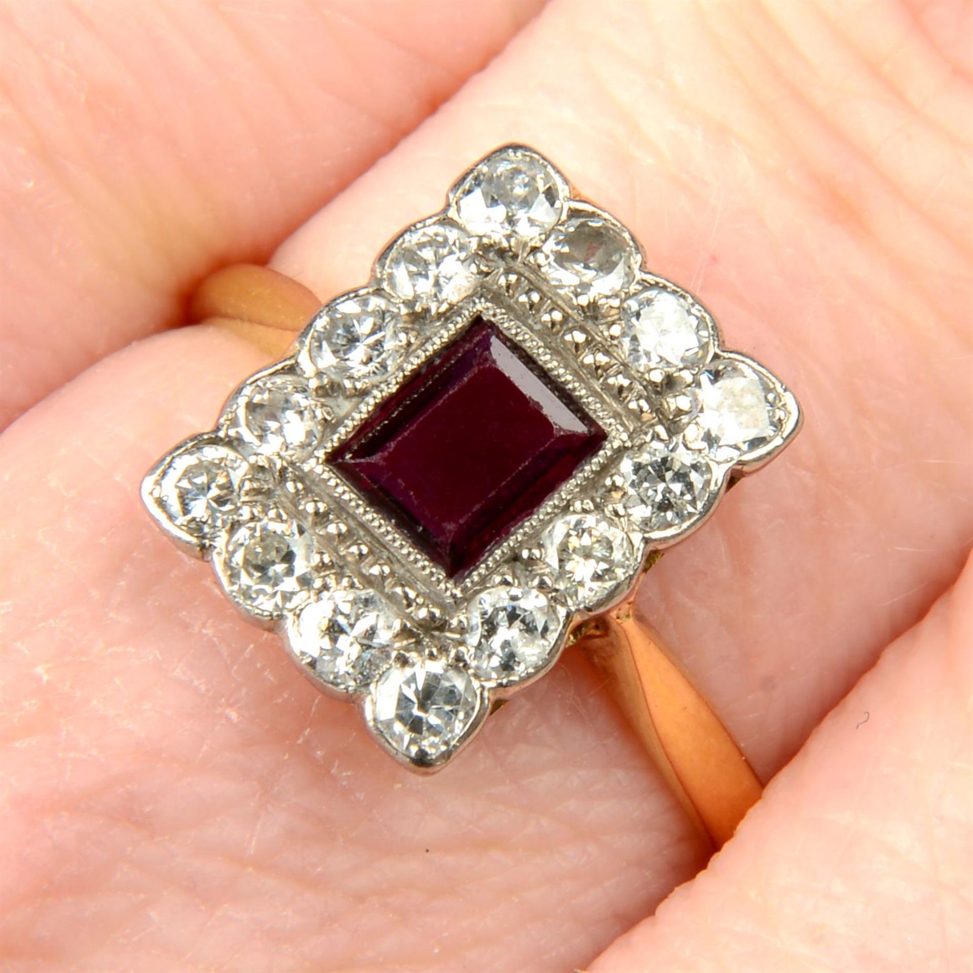 An early 20th century 18ct gold ruby and brilliant-cut diamond cluster ring.