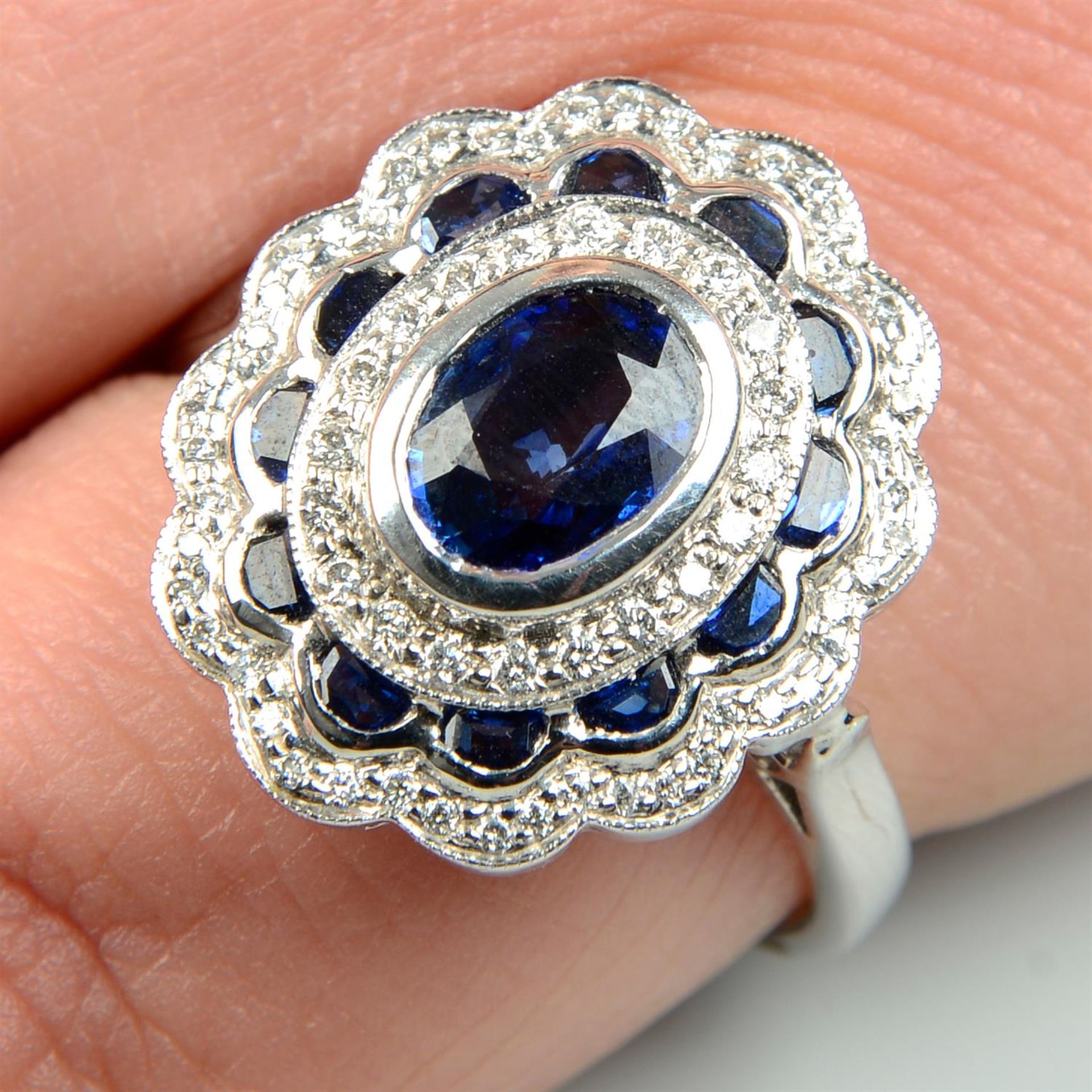 An 18ct gold sapphire and brilliant-cut diamond dress ring.