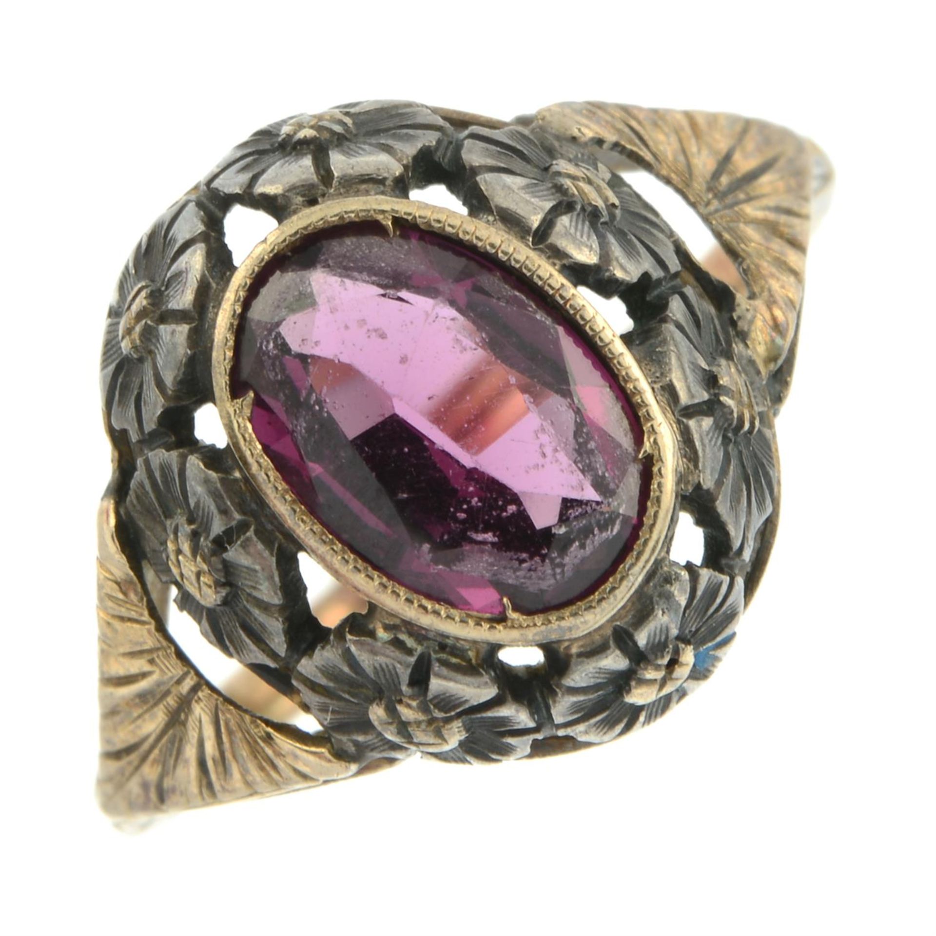 An early 20th century silver and 15ct gold garnet dress ring, with pierced floral surround. - Image 2 of 5