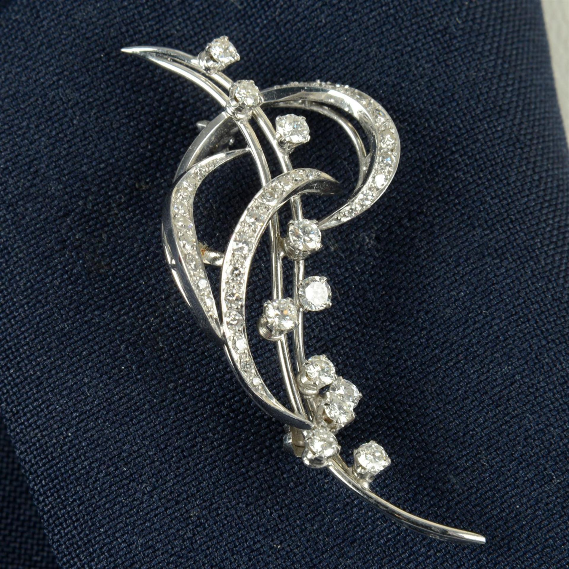 A mid 20th century 18ct gold brilliant and single-cut diamond scroll brooch.