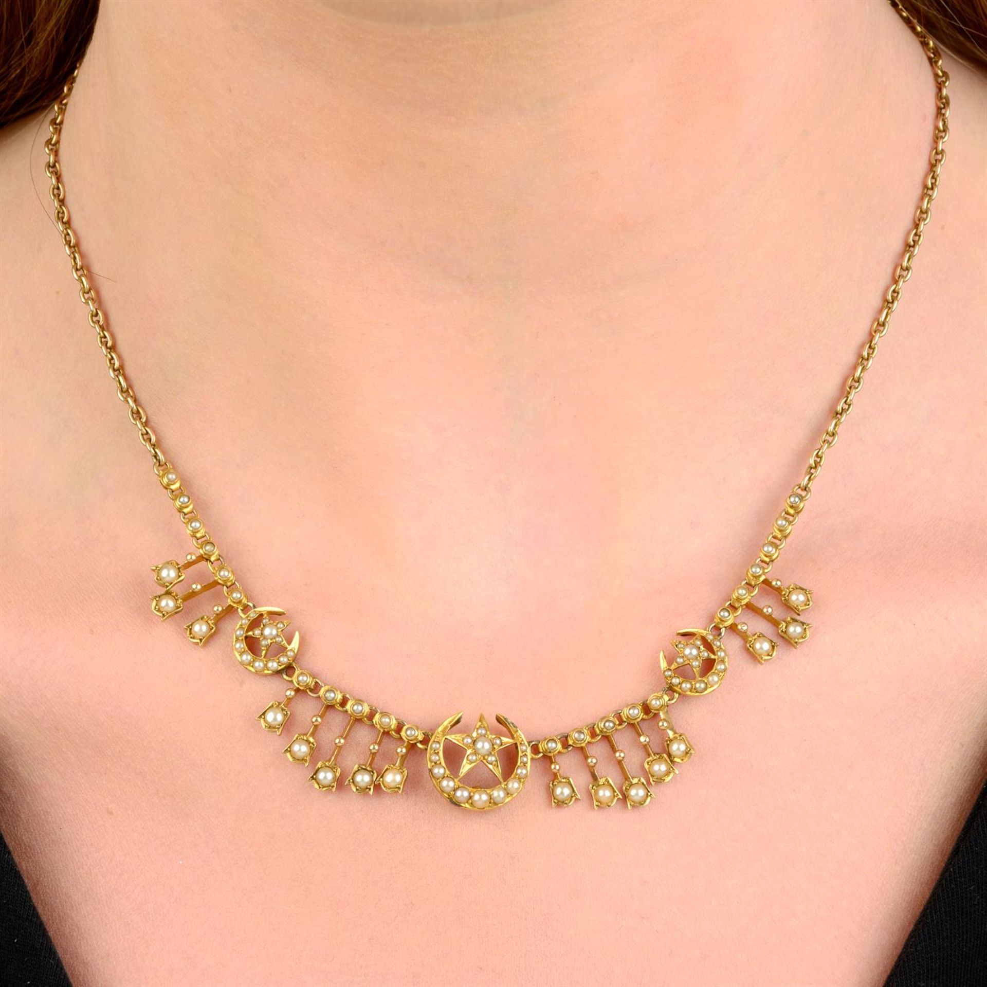 A late Victorian gold split pearl crescent moon and stars motif necklace.