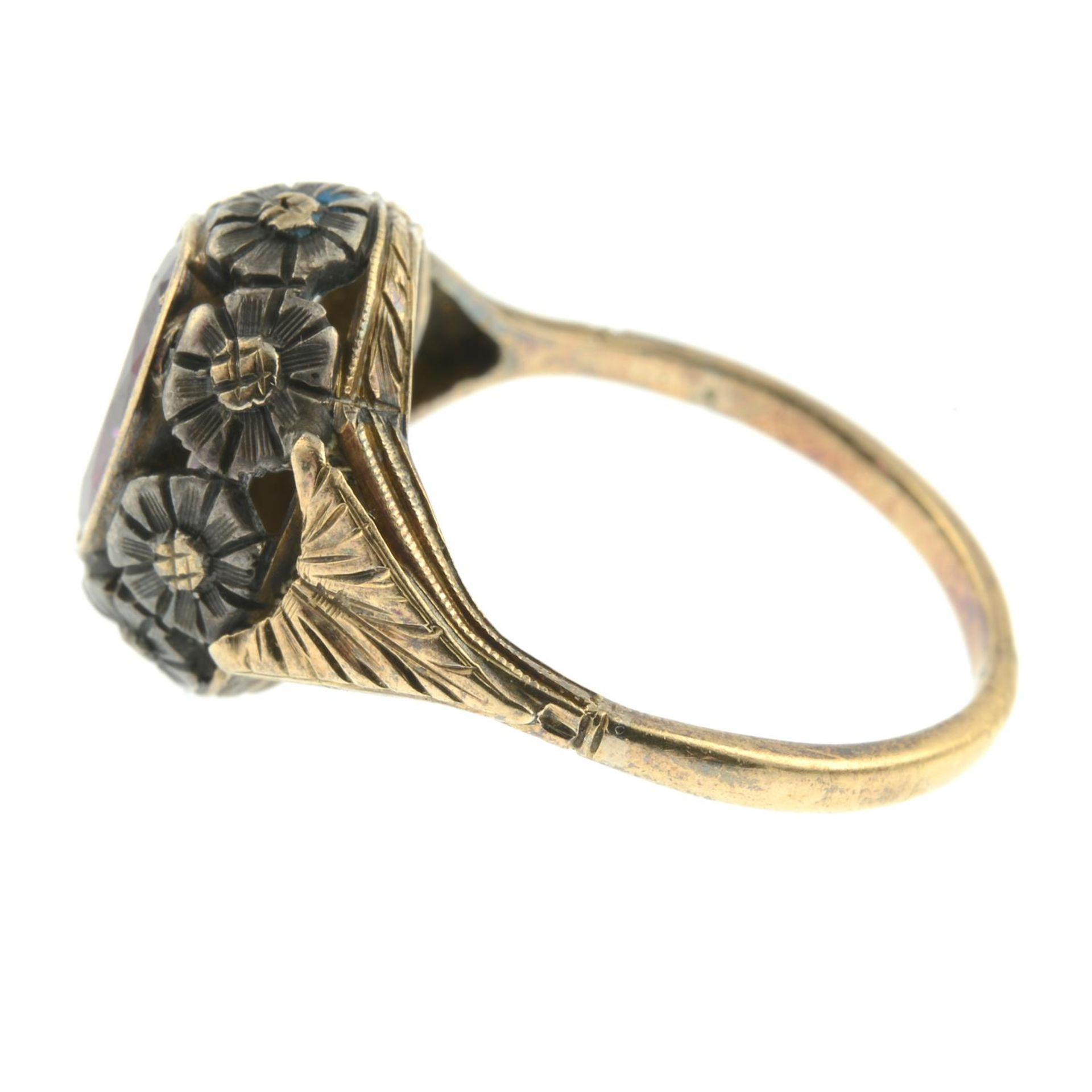 An early 20th century silver and 15ct gold garnet dress ring, with pierced floral surround. - Image 3 of 5