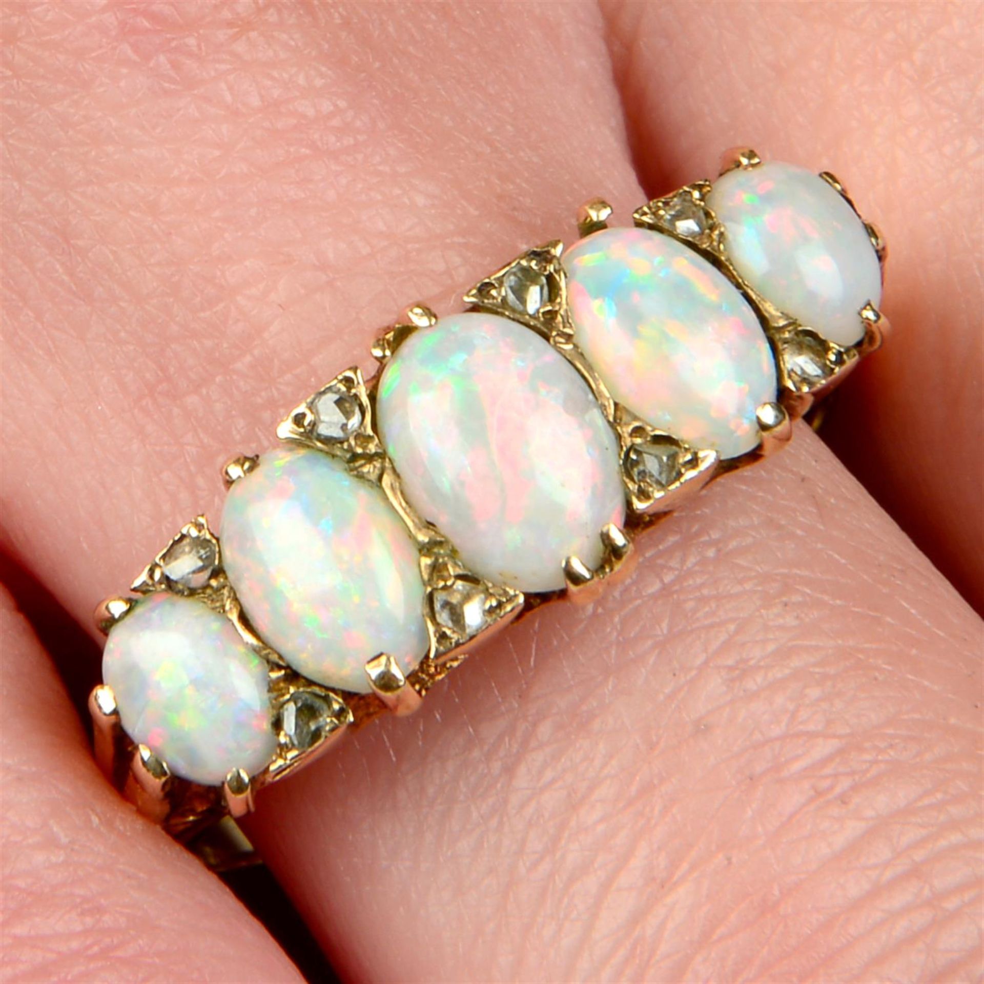 A mid 20th century 9ct gold opal five-stone ring, with rose-cut diamond spacers.