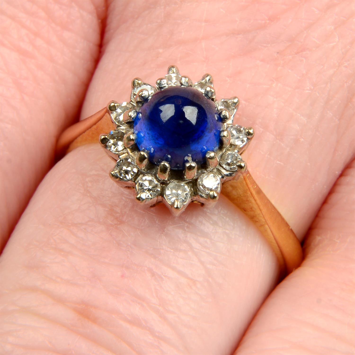 A mid 20th century 18ct gold sapphire cabochon and single-cut diamond cluster ring.