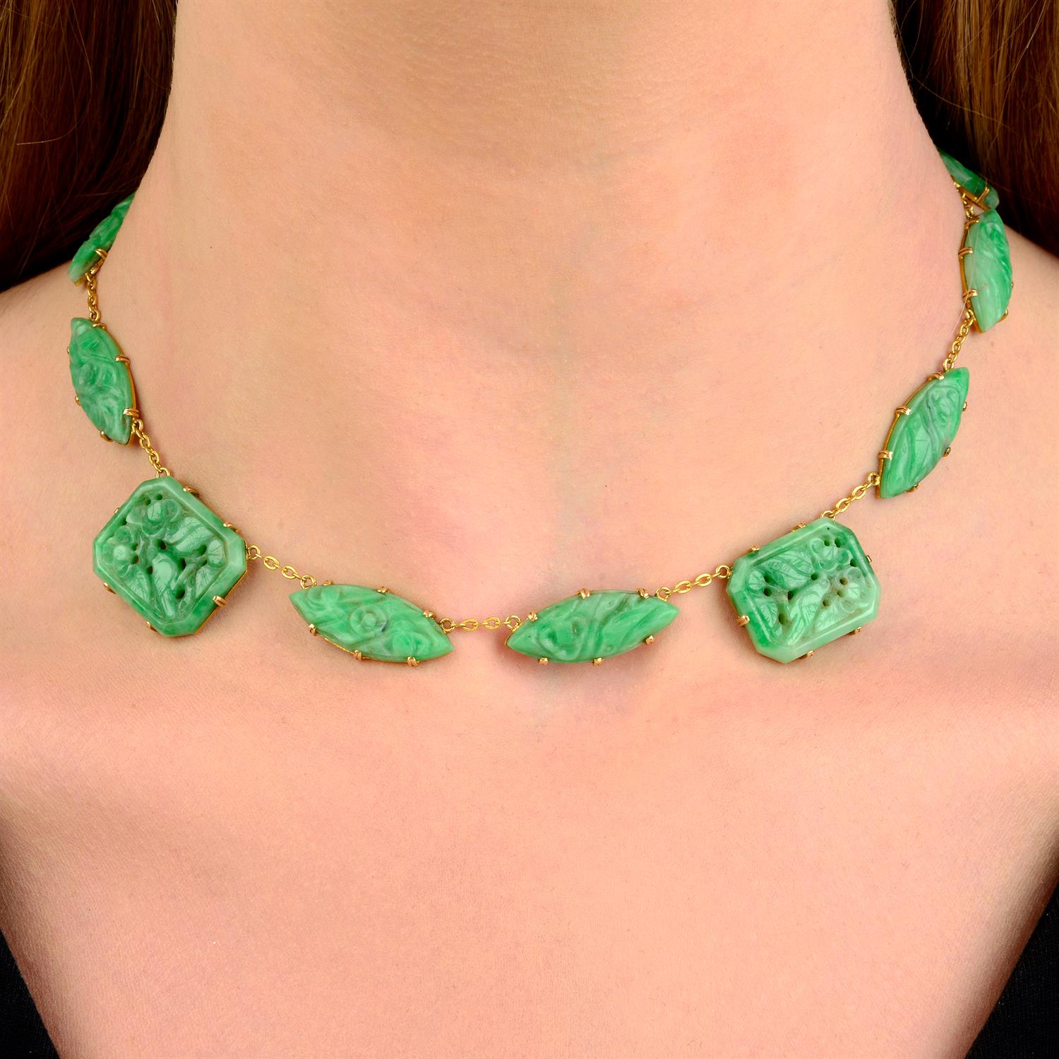 An Art Deco 18ct gold carved and pierced jadeite jade floral and bird motif necklace.