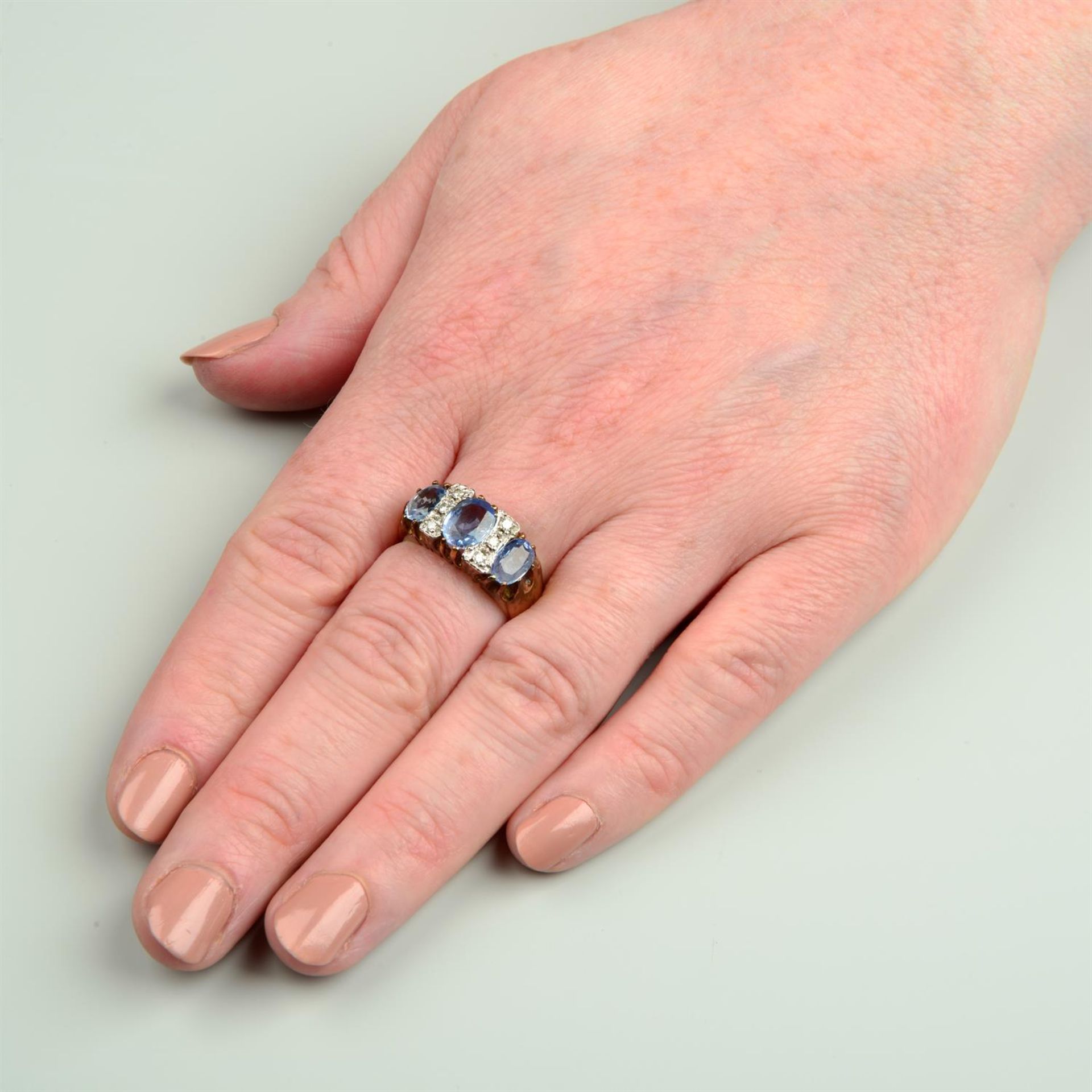 A 9ct gold sapphire three-stone ring, with brilliant-cut diamond spacers. - Image 5 of 5