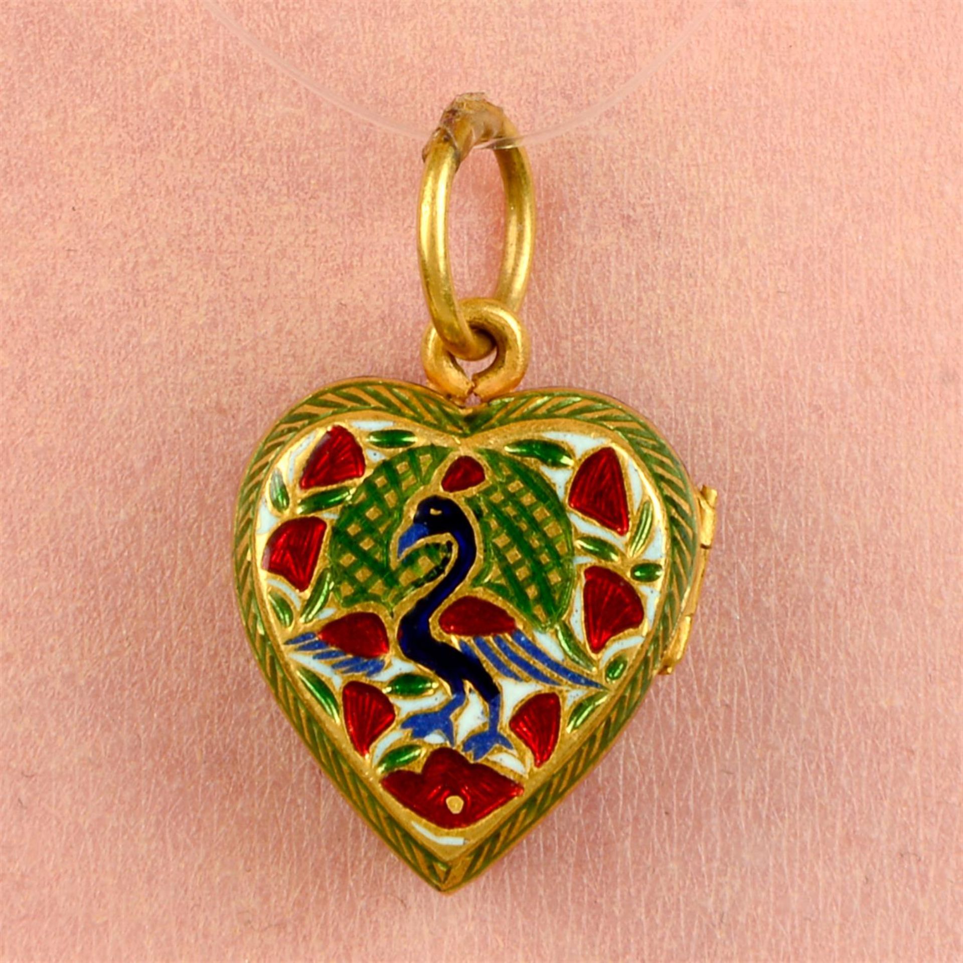 A floral and bird motif enamel heart locket.