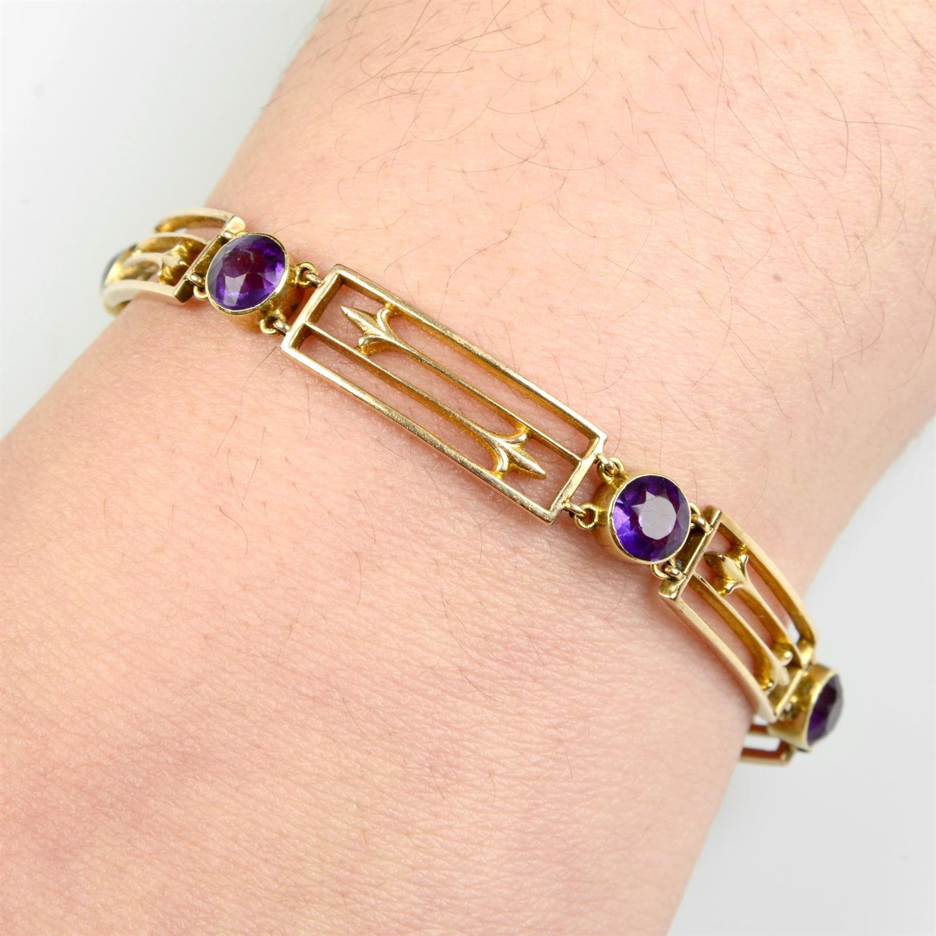 A late Victorian 15ct gold amethyst and openwork panel bracelet.